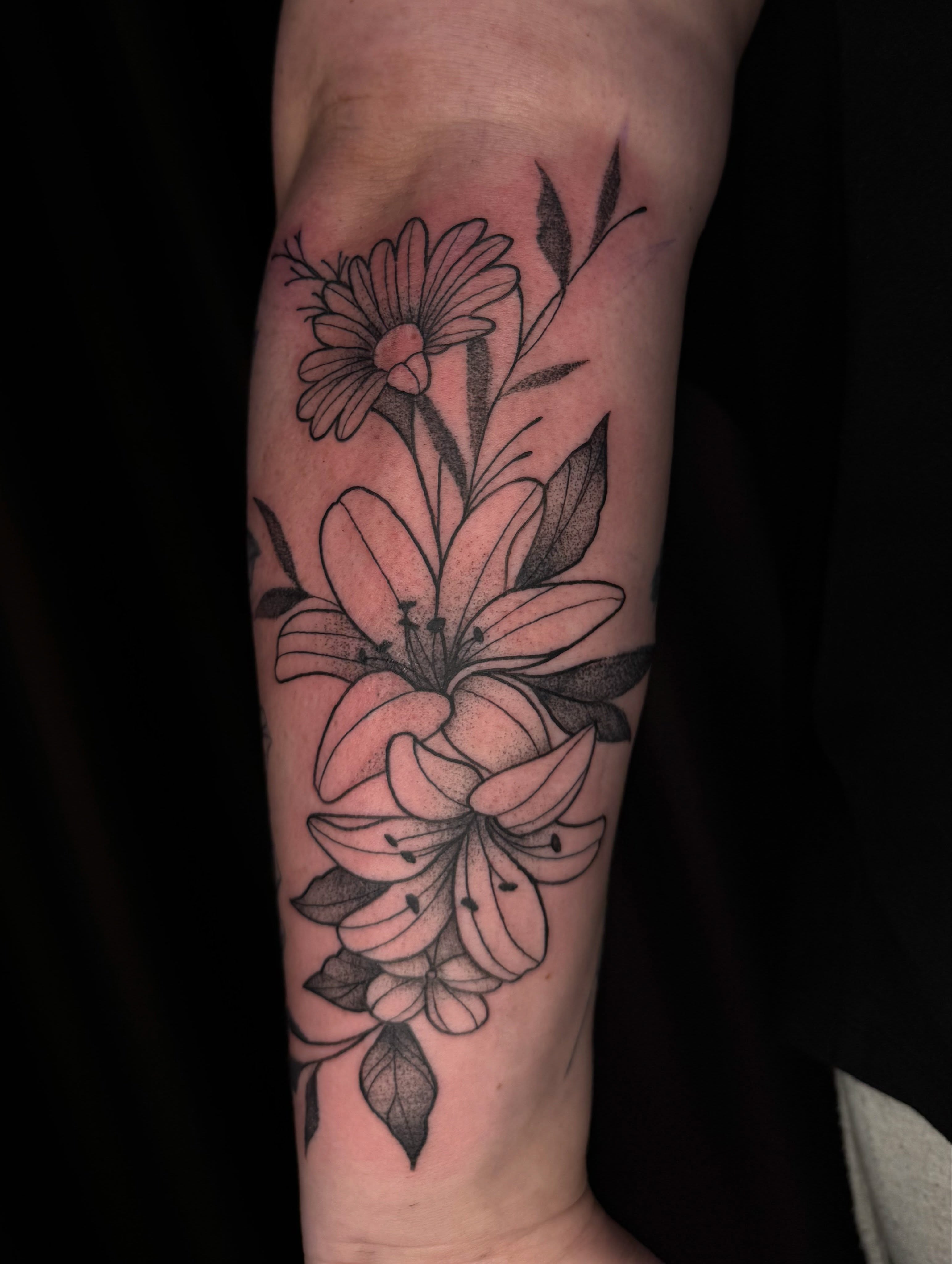 Lilies and daisies black and grey tattoo on the forearm by ✧˖°. Jordan