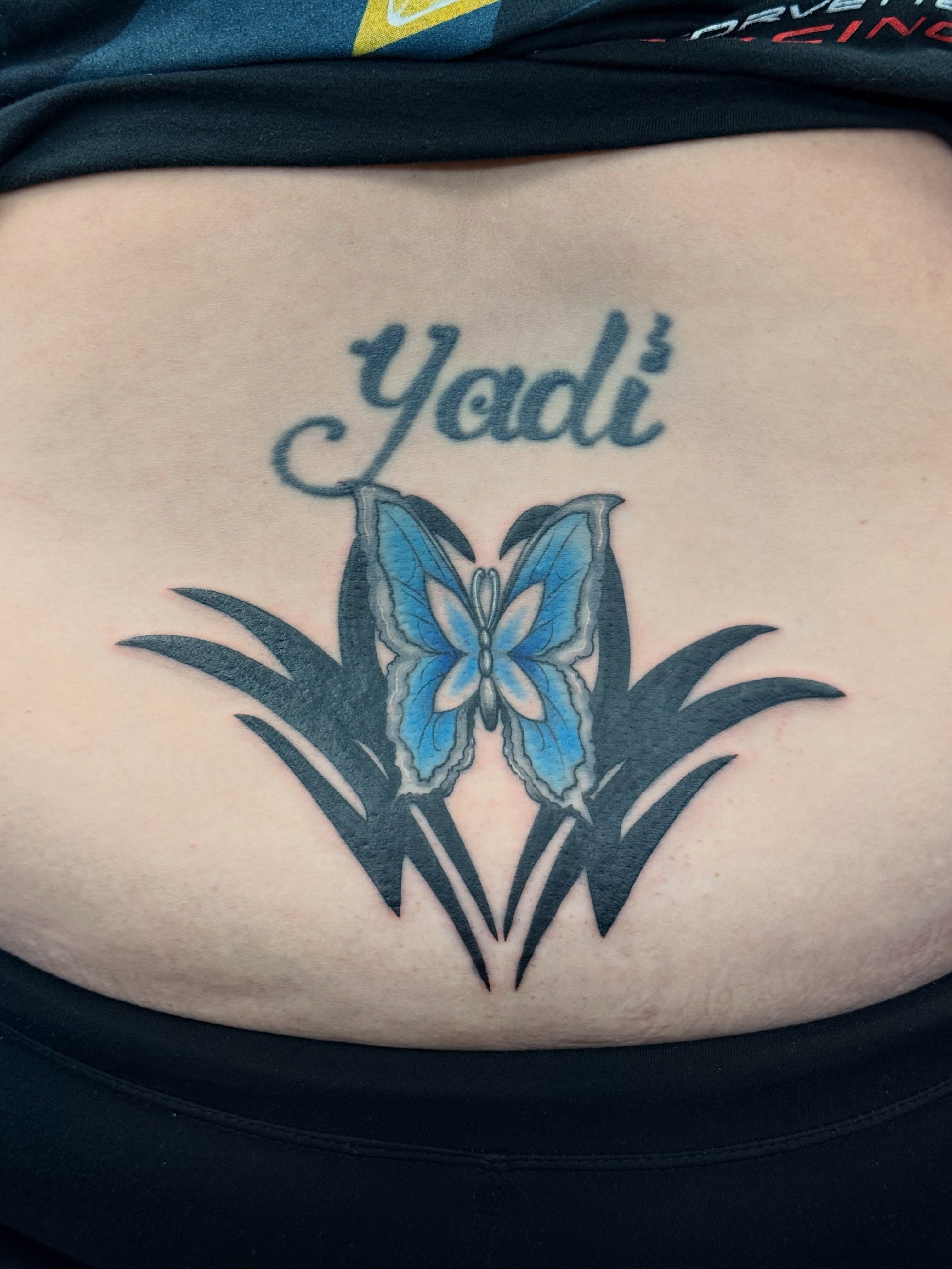 Butterfly and lily new school tattoo on the torso by Chris