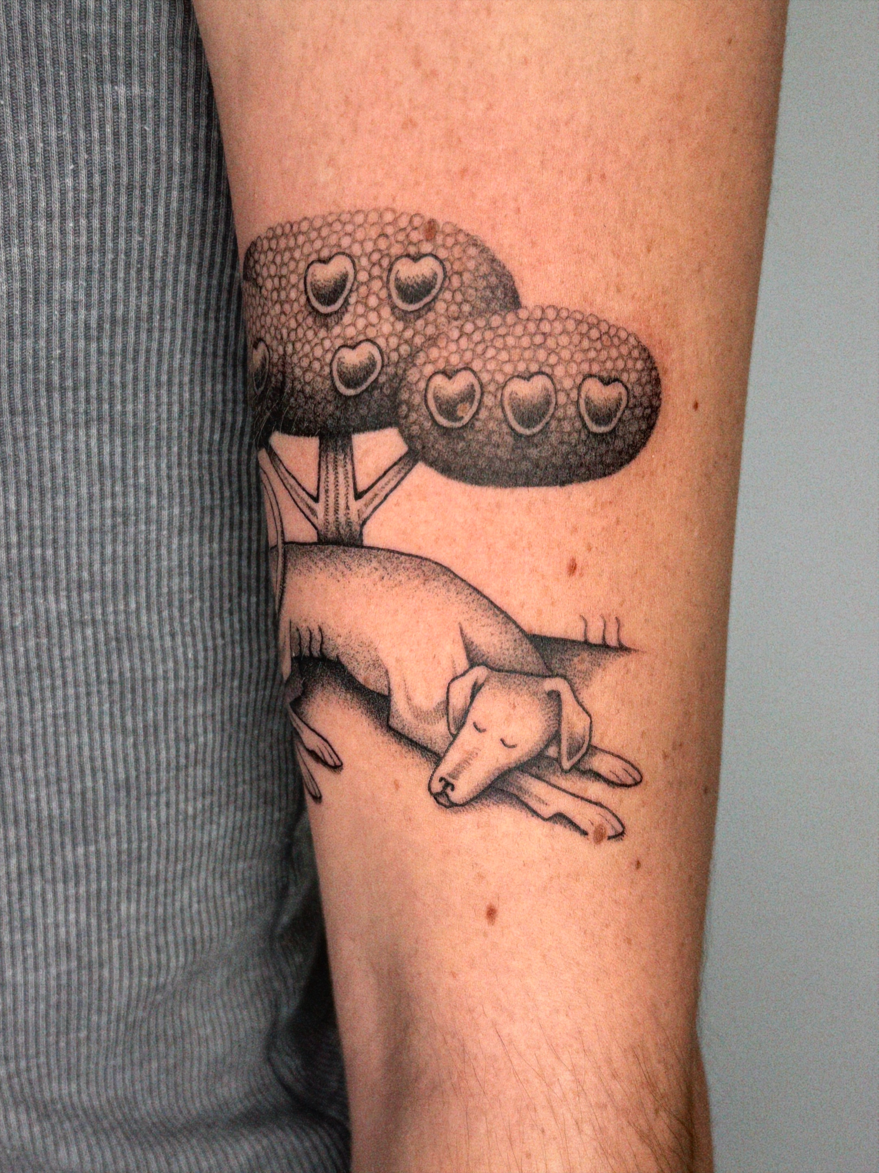 Dog under tree dotwork tattoo on the forearm by @inkshame