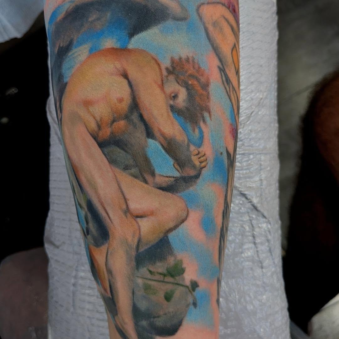 Naked man with lion realism tattoo on the forearm by Nic Skrade, Minneapolis, Minnesota