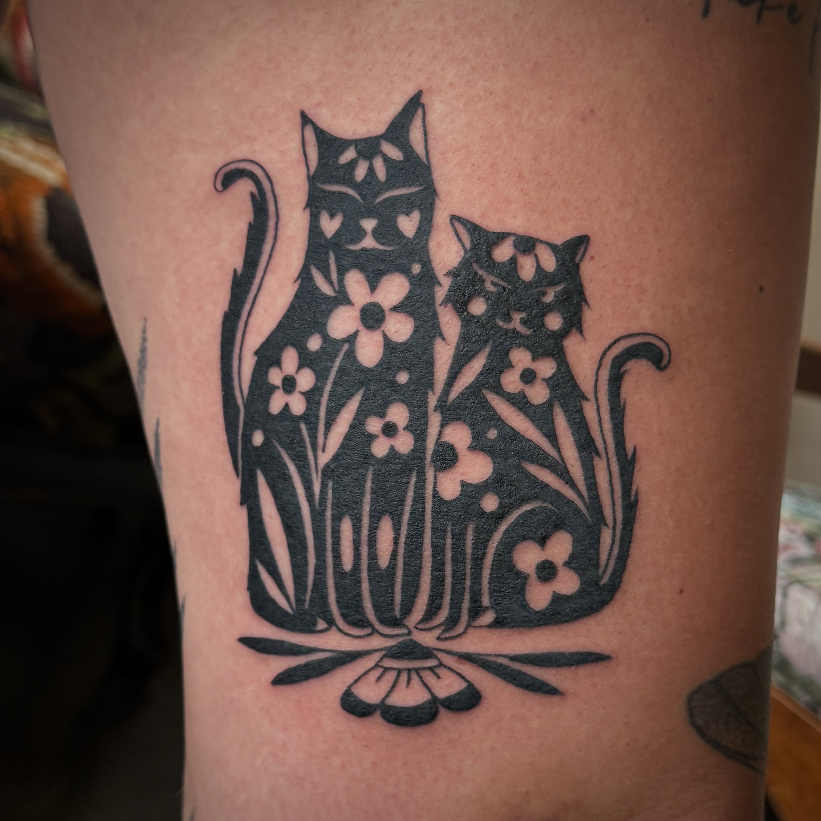 Two cats black and grey tattoo on the thigh by Leah - Tattoo Artist