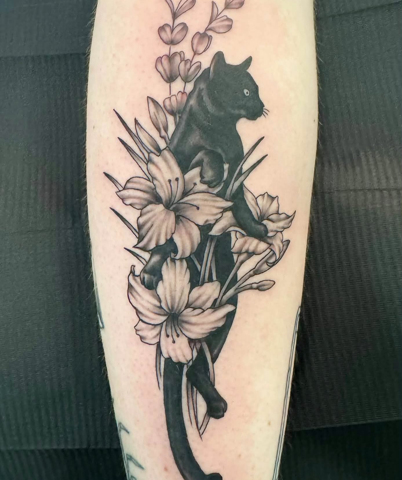 Panther and flowers realism tattoo on the forearm by Skott Kautman, Dubuque, Iowa