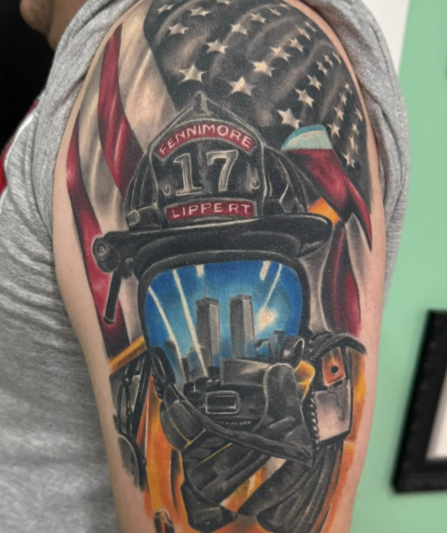 Firefighter helmet realism tattoo on the upper arm by Skott Kautman, Dubuque, Iowa
