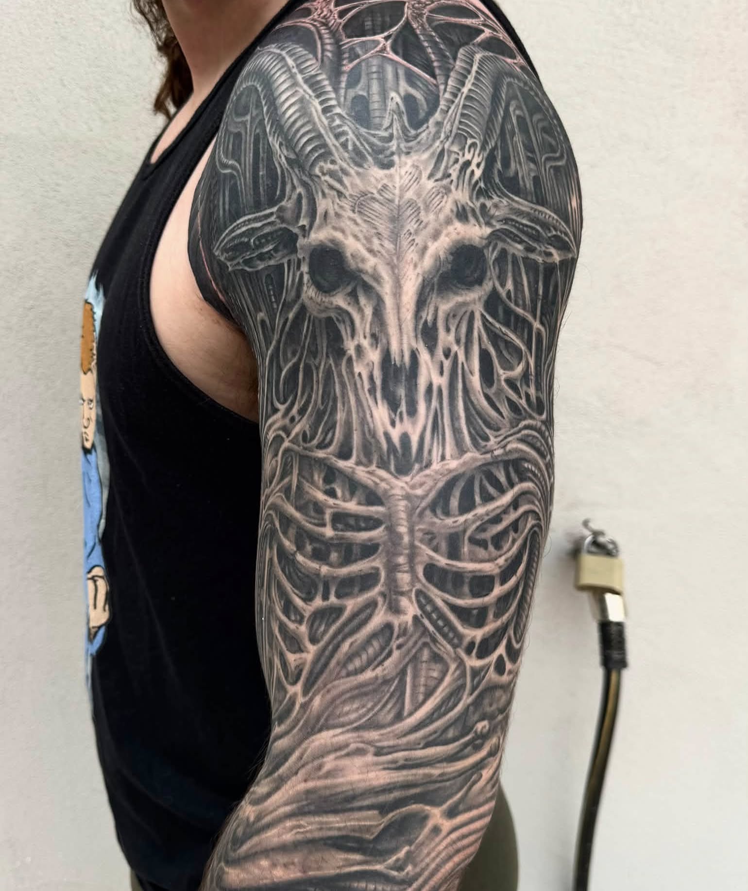Biomechanical skull realism tattoo on the upper arm by Skott Kautman, Dubuque, Iowa