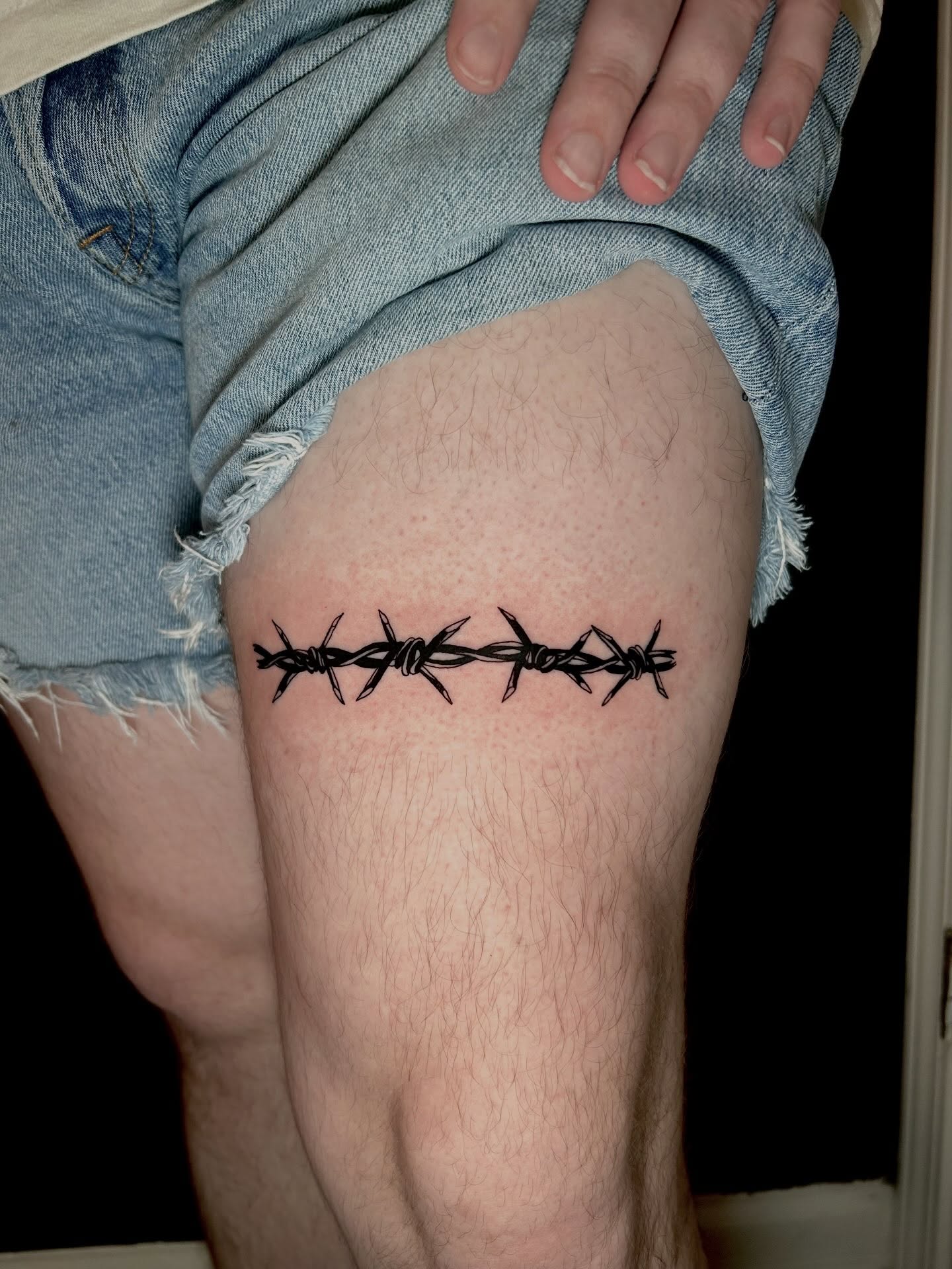 Barbed wire black and grey tattoo on the thigh by KB