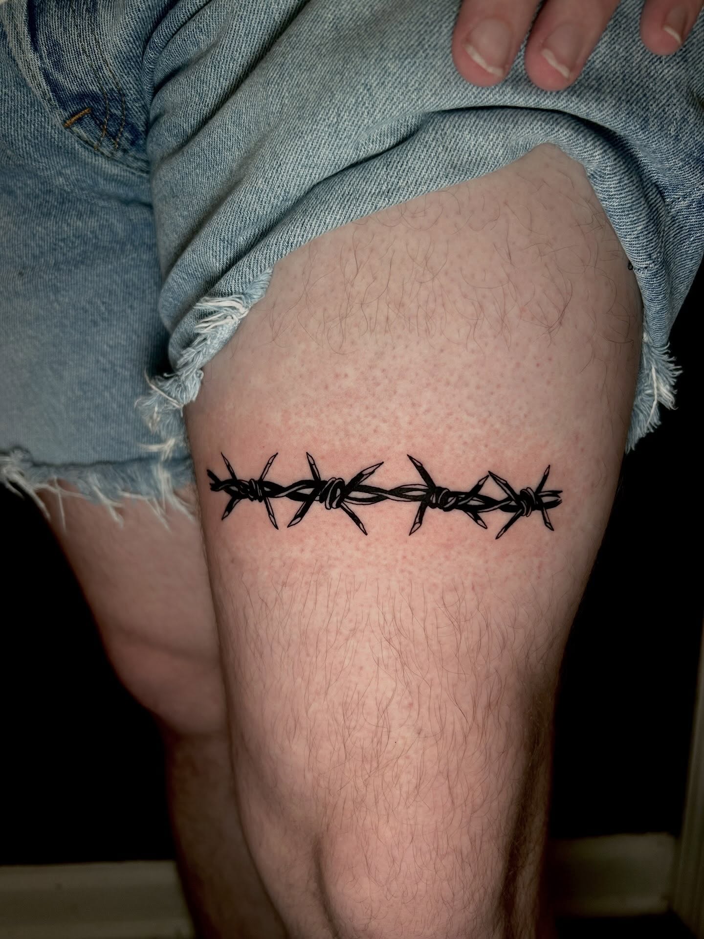 Barbed wire black and grey tattoo on the thigh by KB