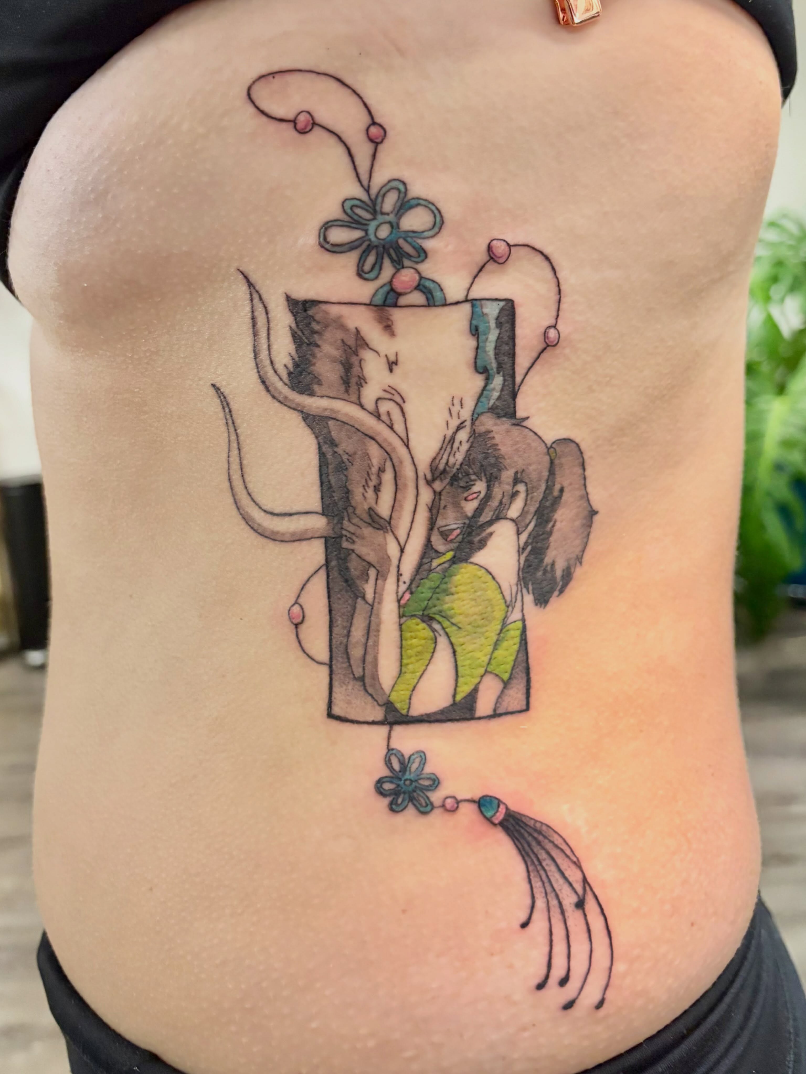 Elephant and woman illustrative tattoo on the torso by Deni Carolina