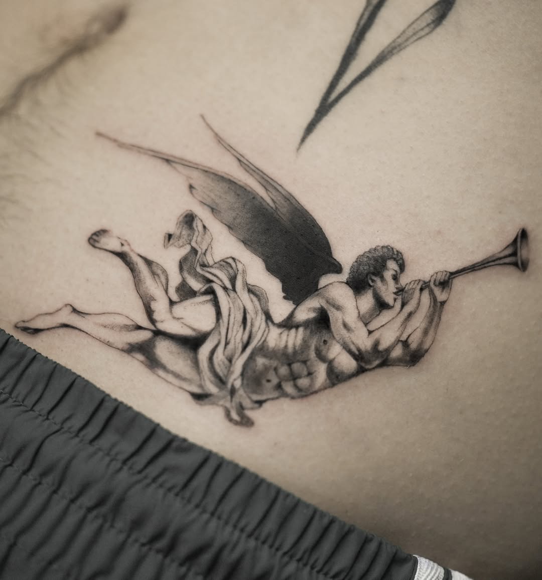 Angel with trumpet black and grey tattoo on the thigh by Hery Anwar