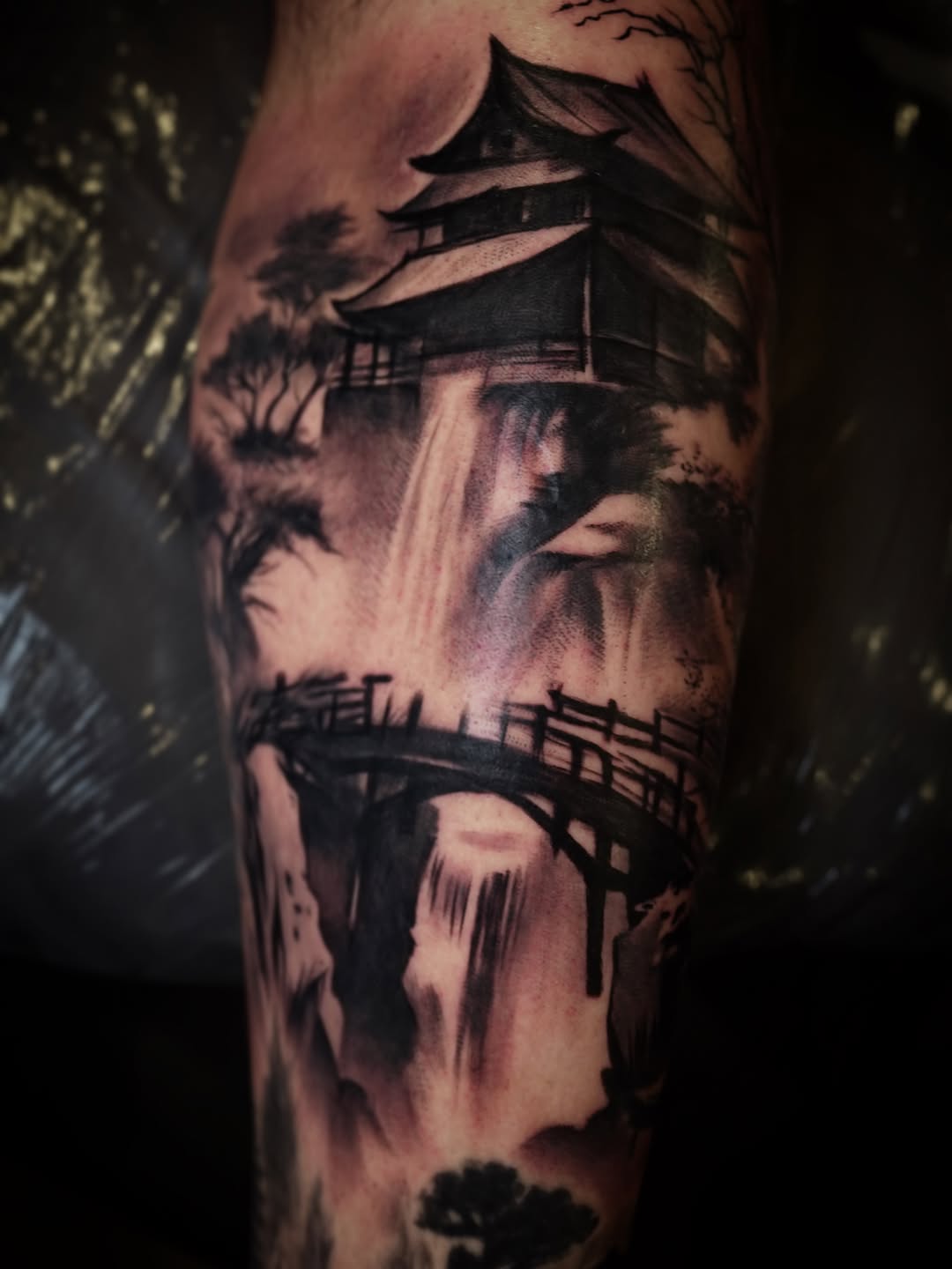 Japanese castle and waterfall surrealism tattoo on the forearm by Erick Satchell II
