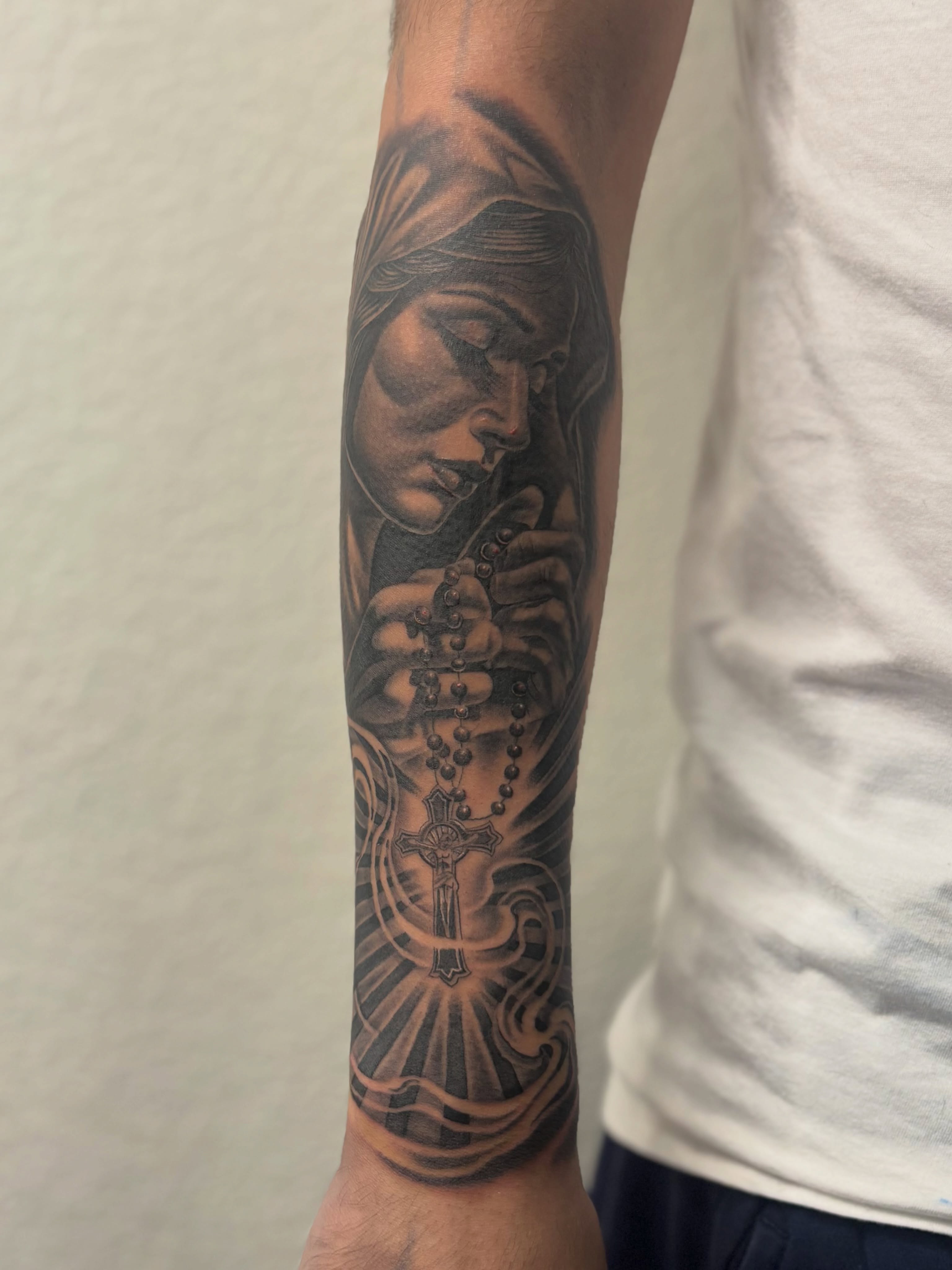 Praying woman realism tattoo on the forearm by @tattoosbyadrian