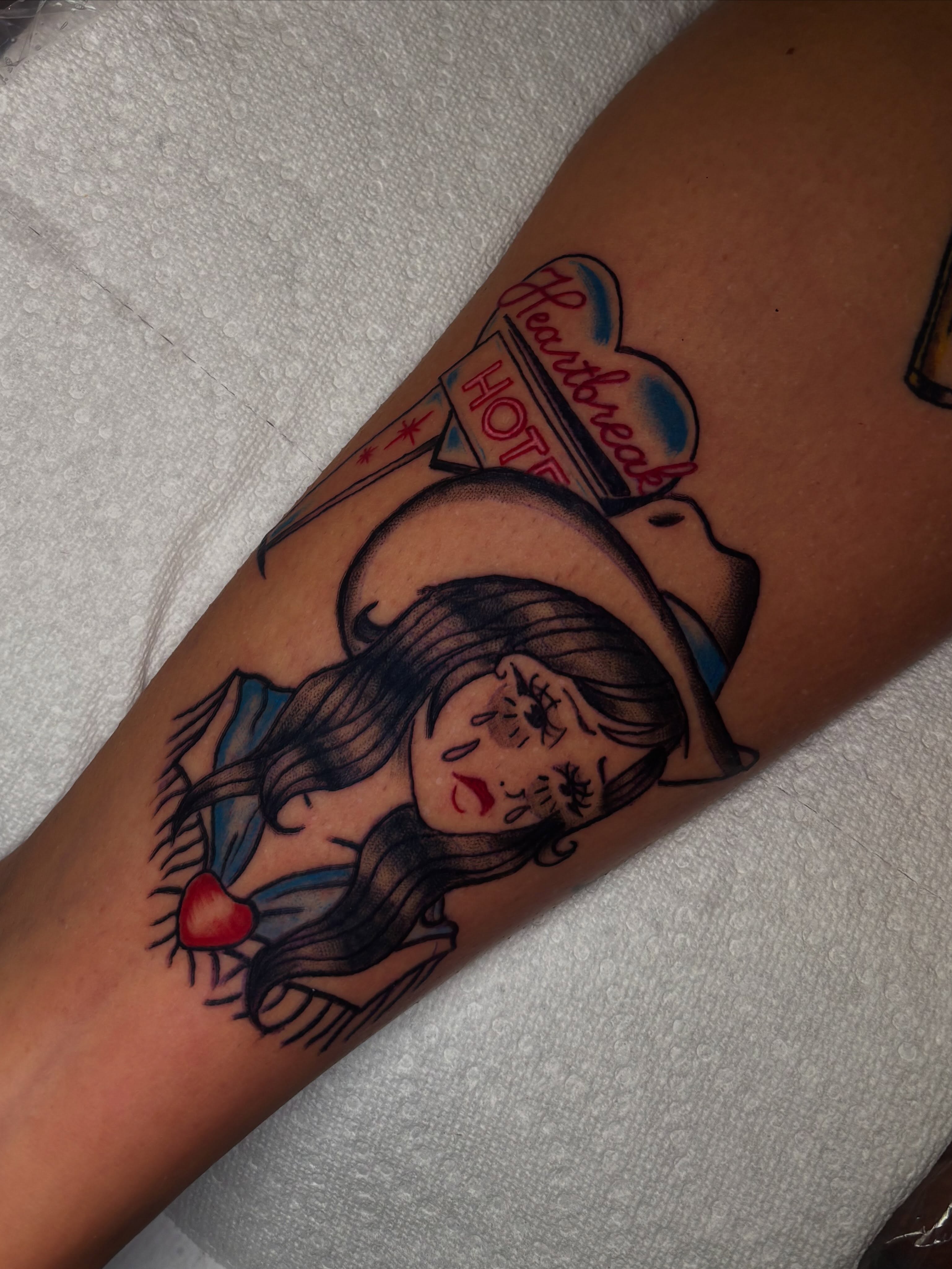 Woman with heart American traditional tattoo on the forearm by Haley Byers