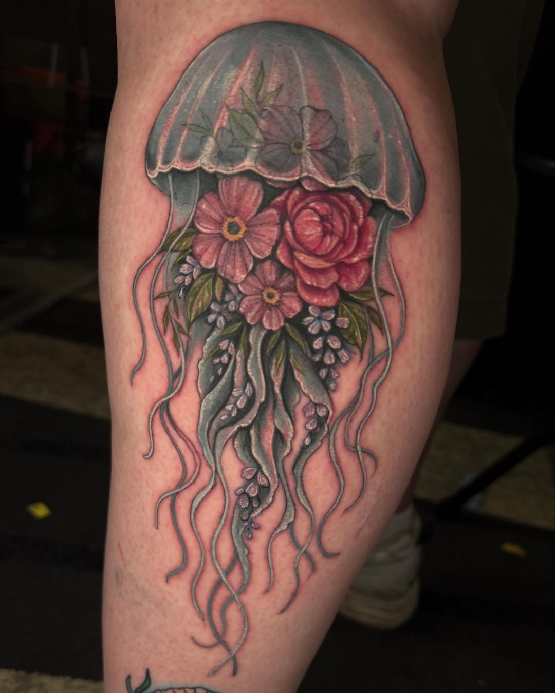Jellyfish with flowers realism tattoo on the thigh by Cassandra Sanik, Ballston Spa, New York