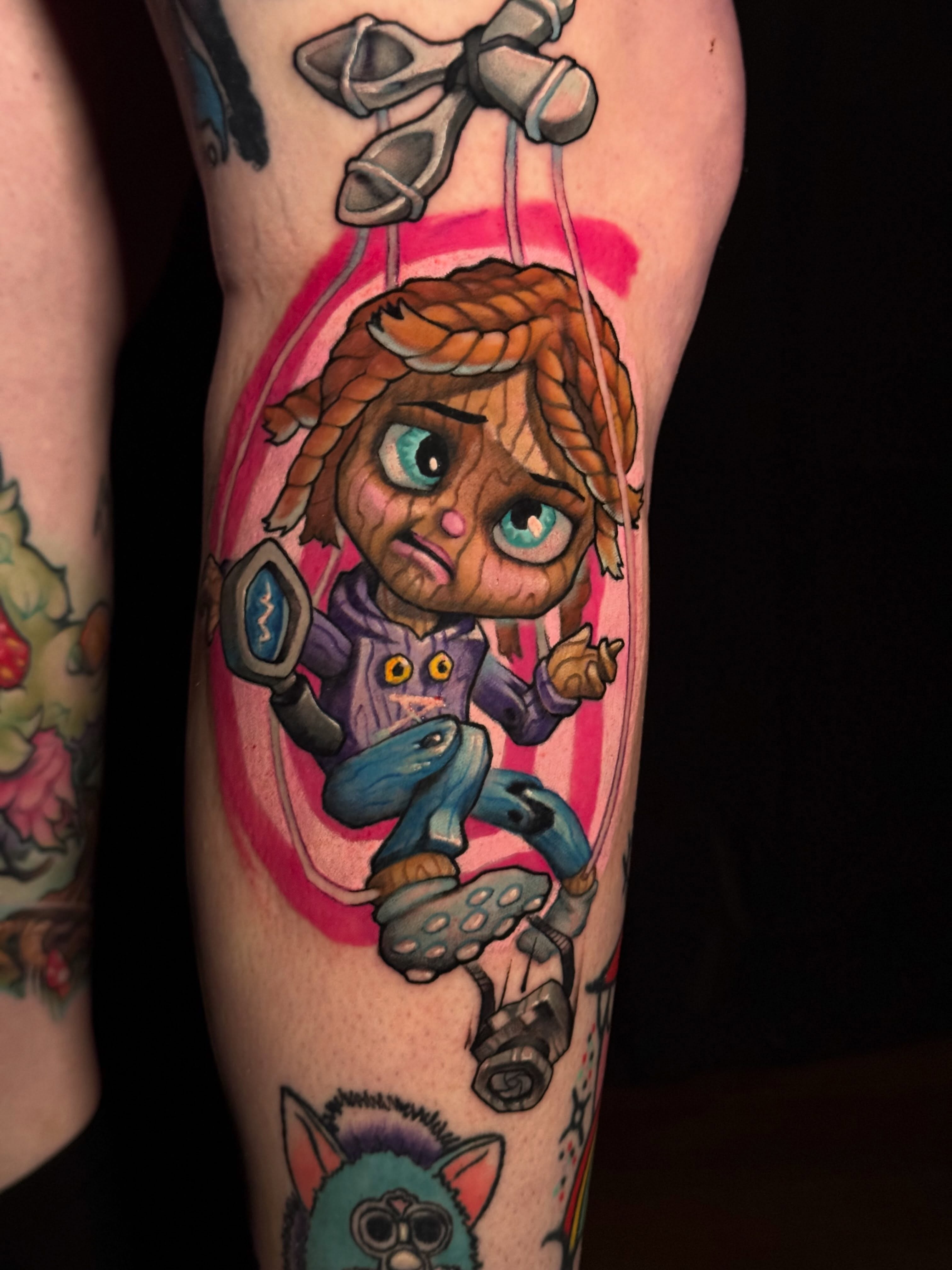 Puppet character illustrative tattoo on the forearm by Tatgunjoe, Salt Lake City, Utah