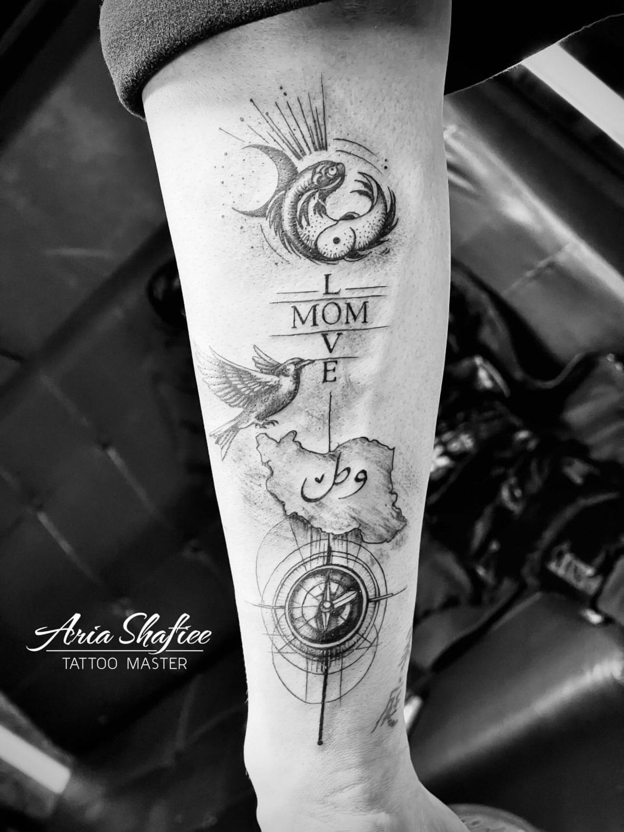 Love and map black and grey tattoo on the forearm by Aria Shafiee