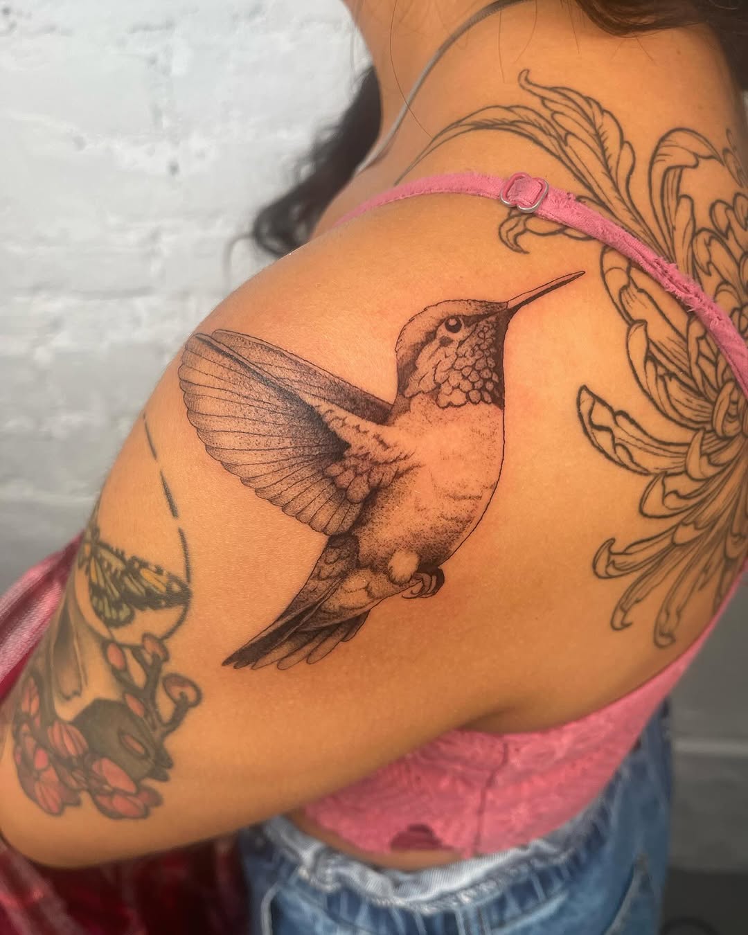 Hummingbird fine line tattoo on the shoulder by Authentics NYC