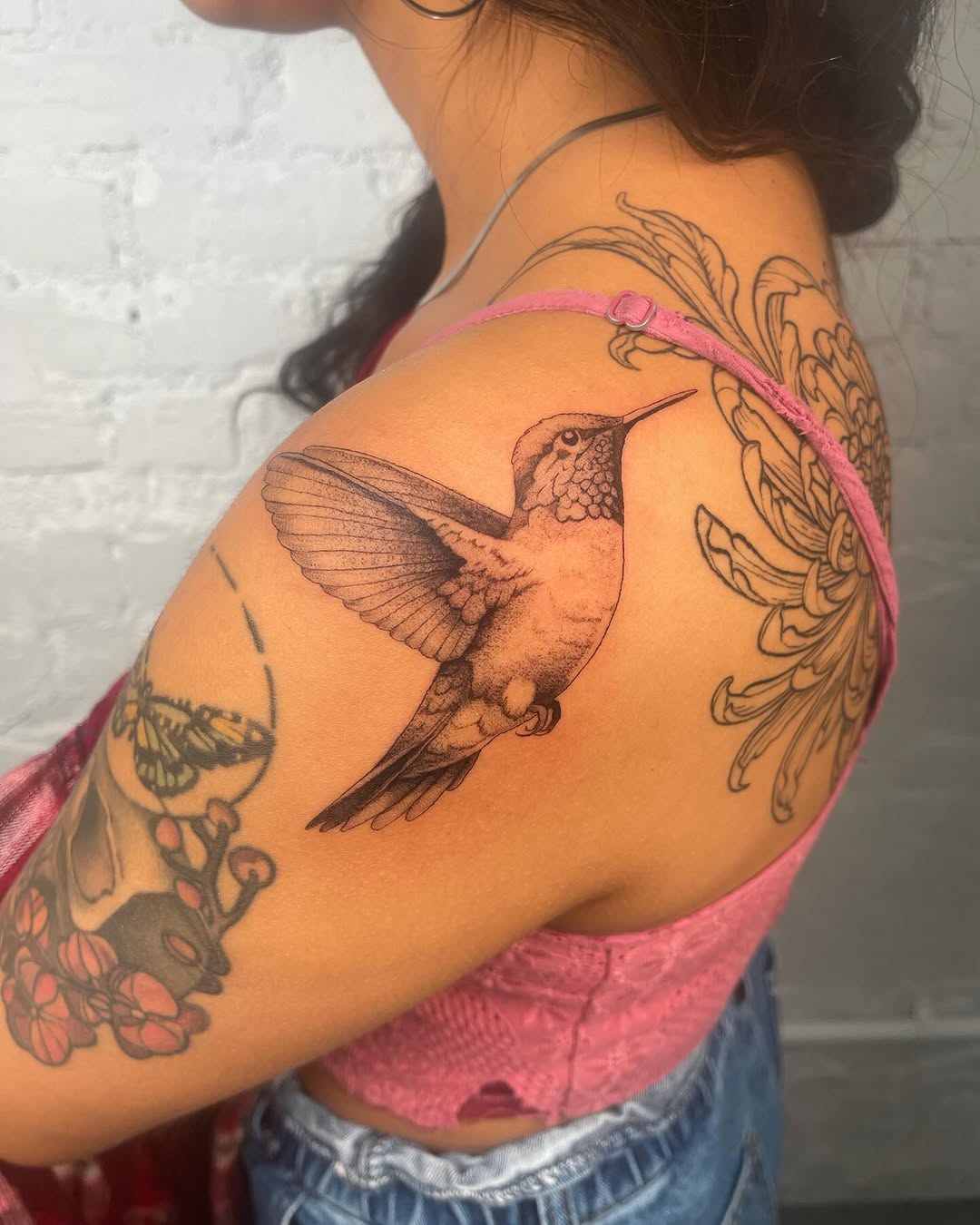 Hummingbird fine line tattoo on the shoulder by Authentics NYC