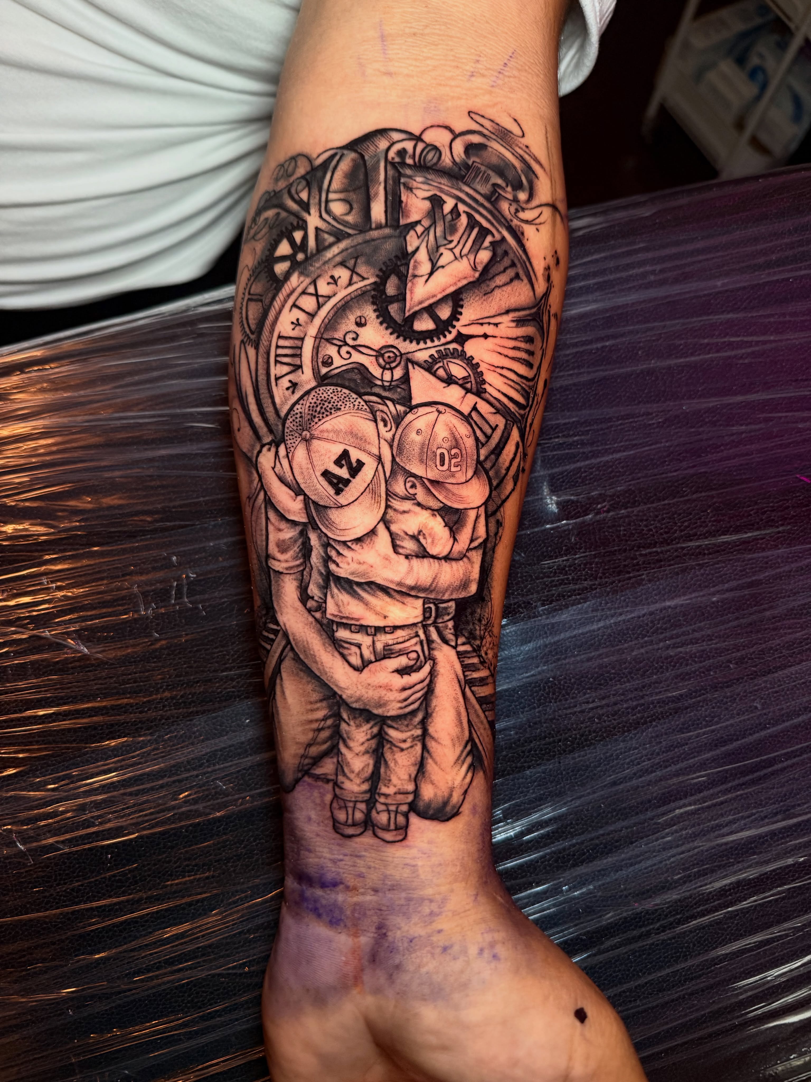 Astronauts realism tattoo on the forearm by Brandt Norcross