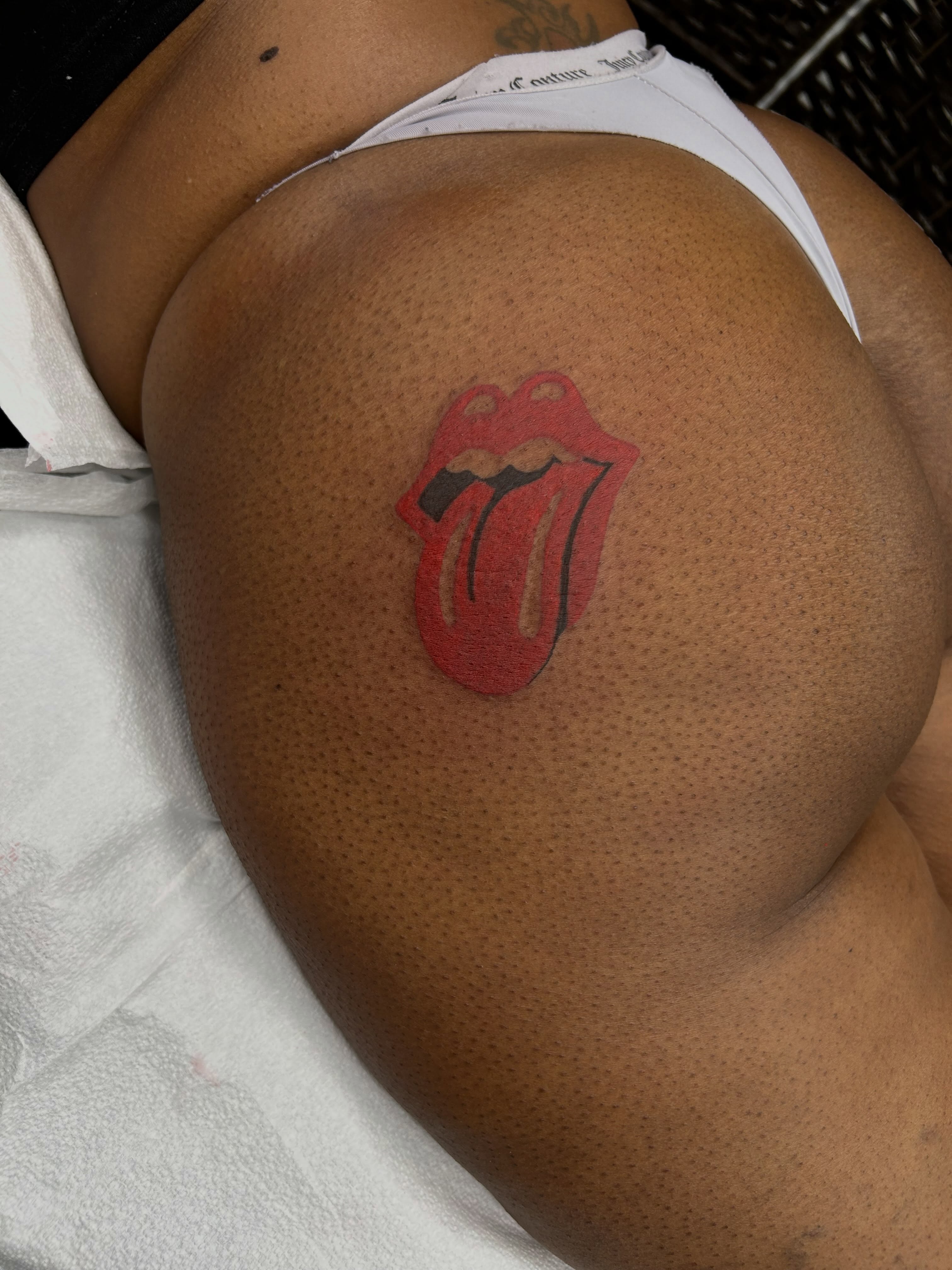 Rolling stones tongue dotwork tattoo on the thigh by Brittany Brutal
