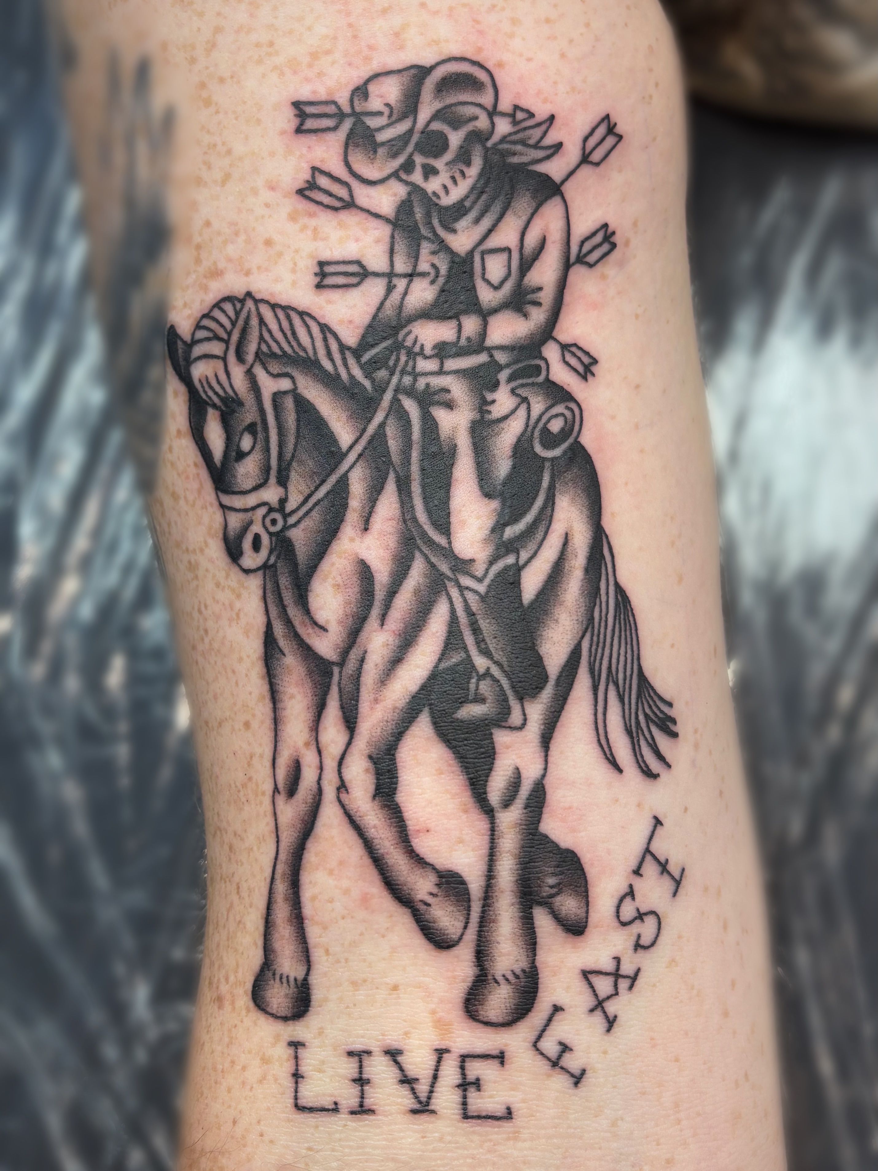 Skeleton on horseback black and grey tattoo on the forearm by Bree Burgess