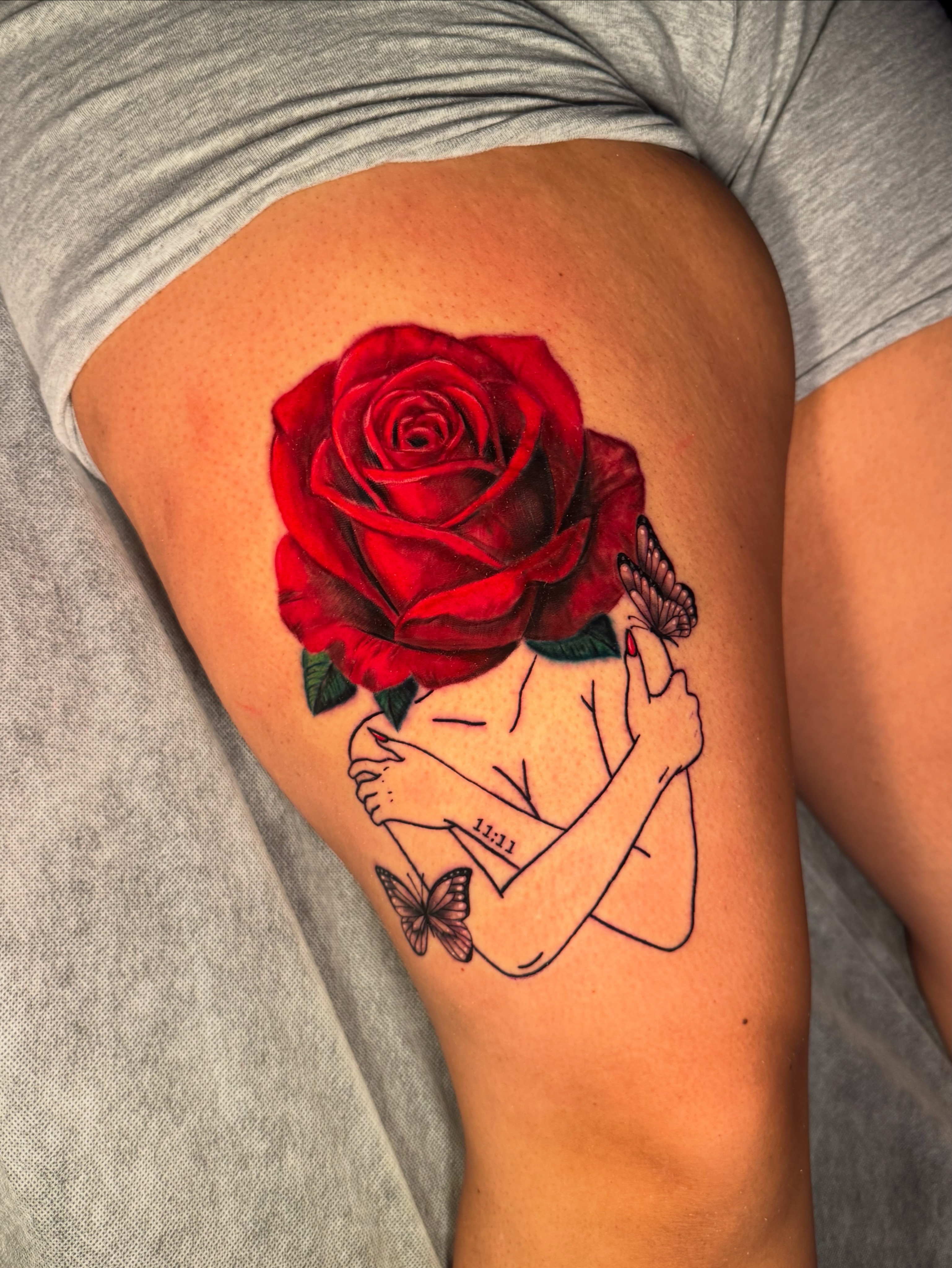 Red rose realism tattoo on the thigh by Ericka Hampton, Ferndale, Michigan