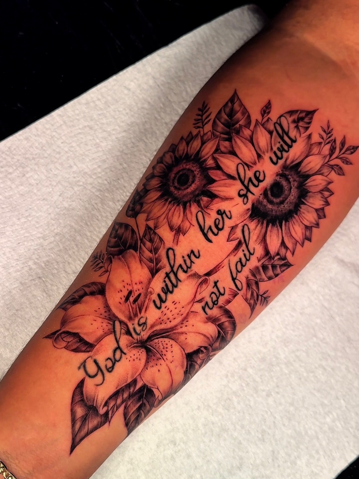 Sunflowers and lilies realism tattoo on the forearm by Ericka Hampton, Ferndale, Michigan