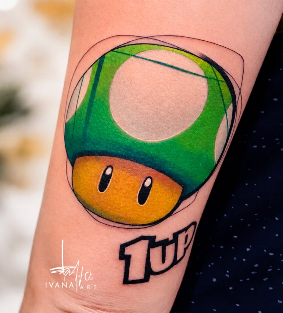 1UP mushroom new school tattoo on the forearm by Ivana Belakova