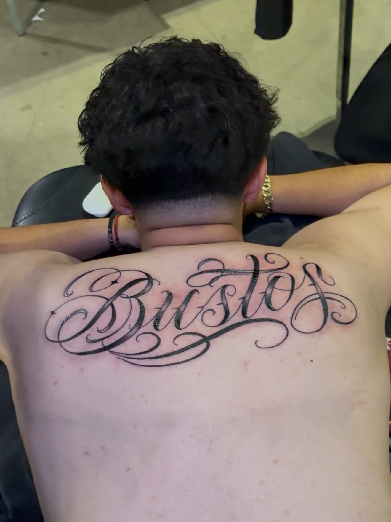 Bustos lettering script tattoo on the back by Erick @ AZTEC_TATT