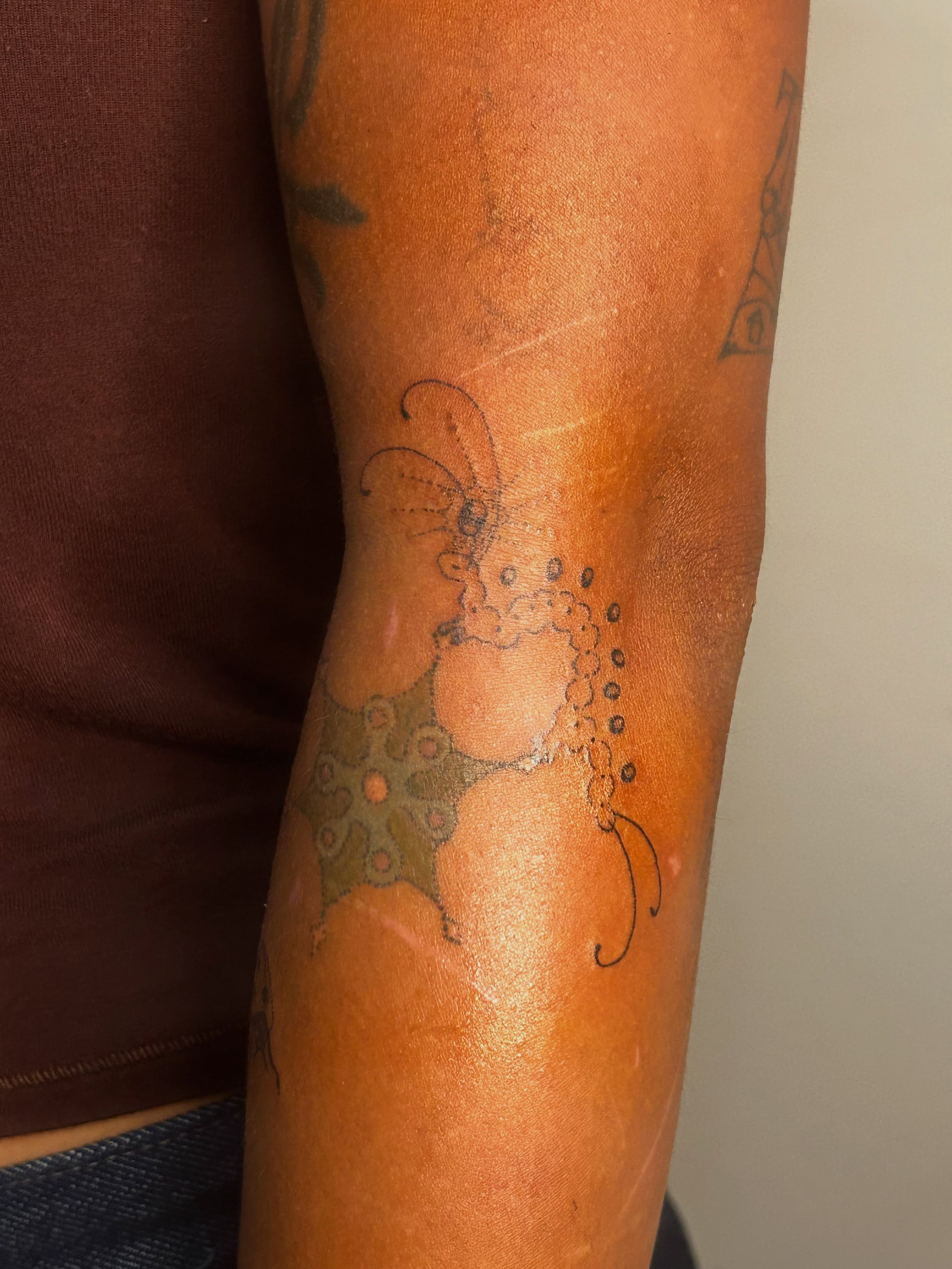 Abstract floral design dotwork tattoo on the forearm by Nicolette