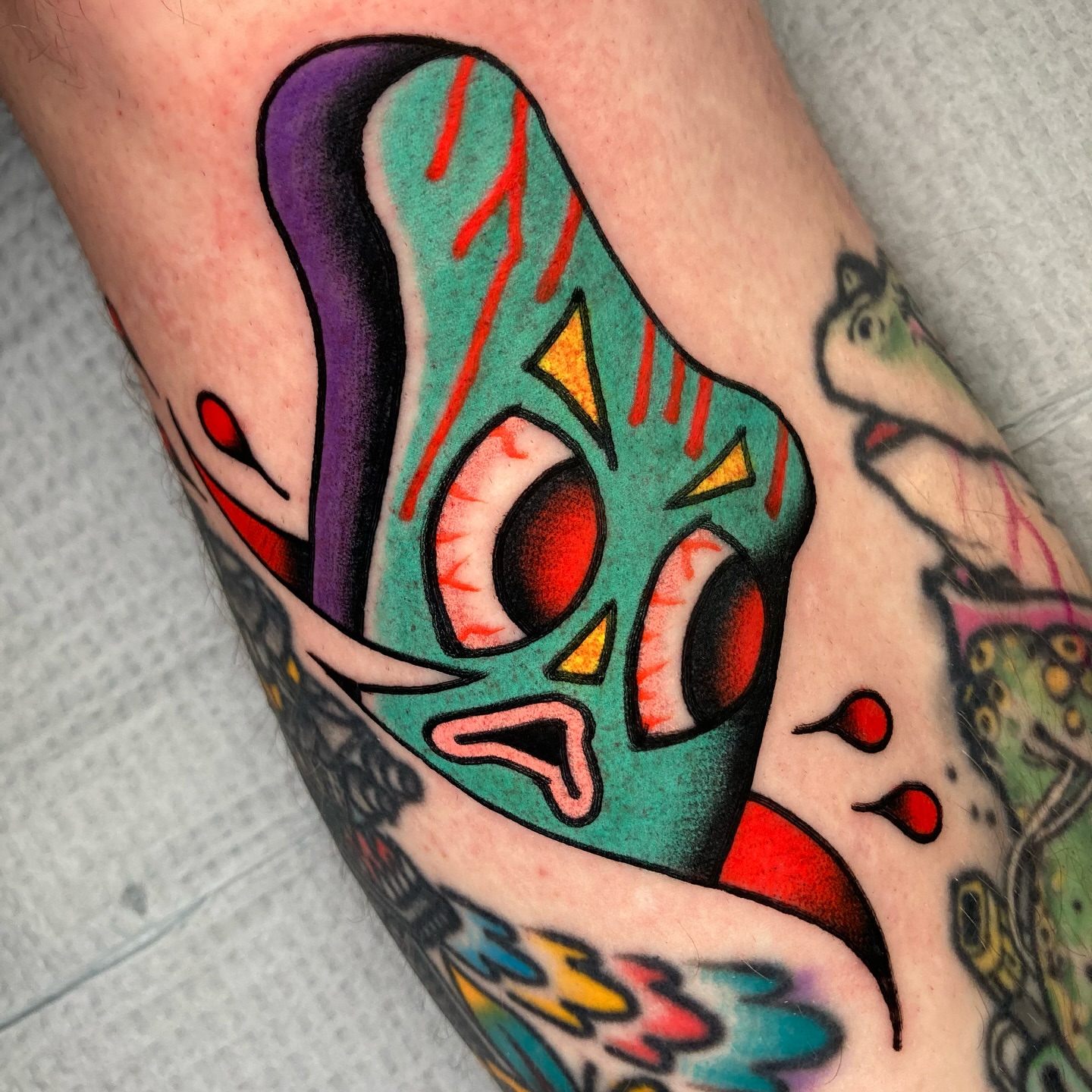 Mask American traditional tattoo on the forearm by 🌴Nick Hetzel🌴, Saint Petersburg, Florida