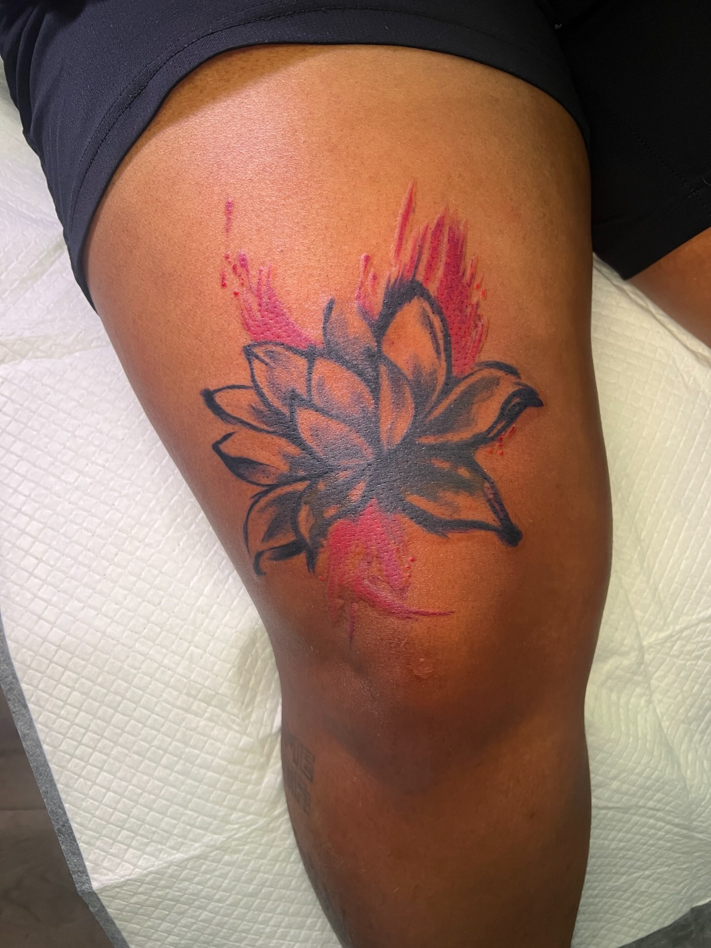 Lotus flower watercolor tattoo on the thigh by Justx4rt