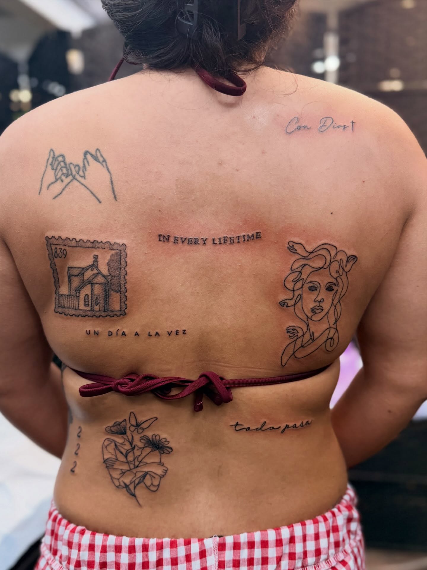 Stamps, hands, woman, flowers, numbers black and grey tattoo on the back by Alesia
