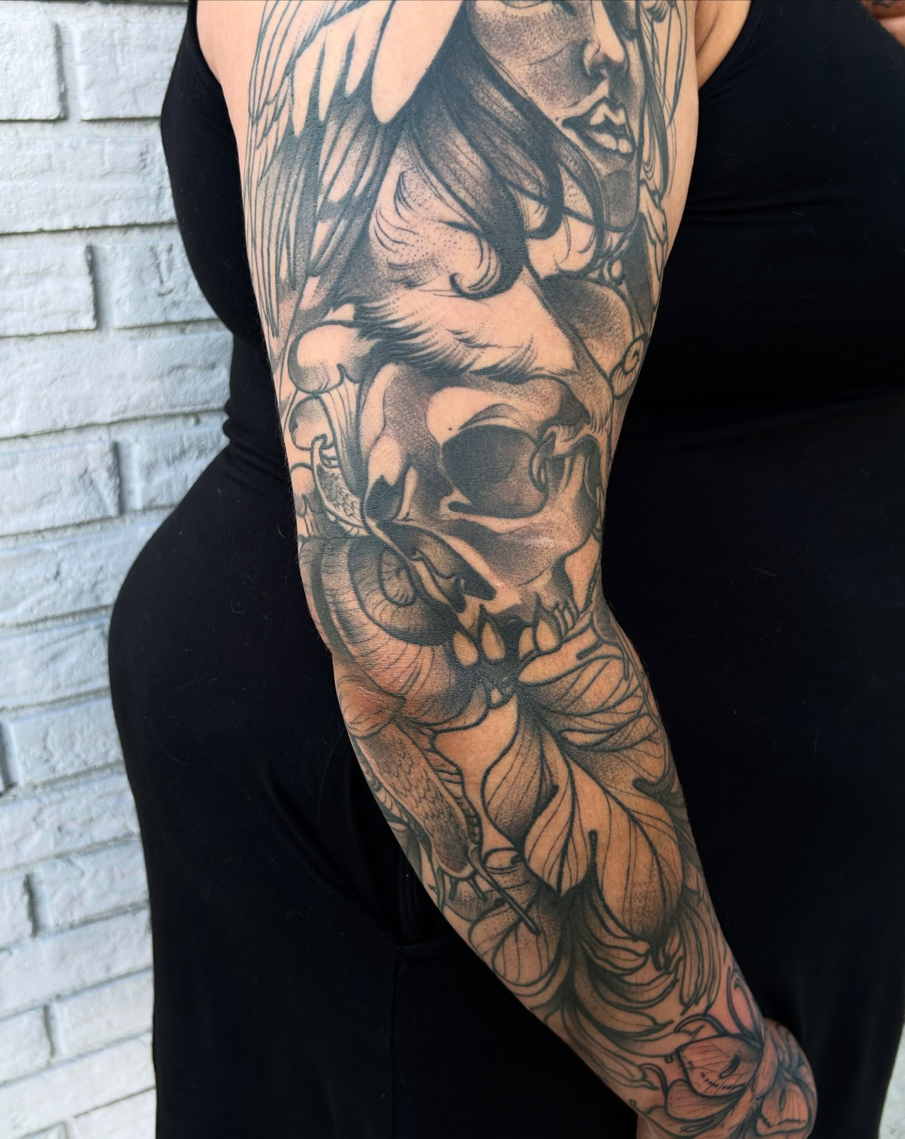Skull and wings realism tattoo on the forearm by Tatijana., Kettering, Ohio