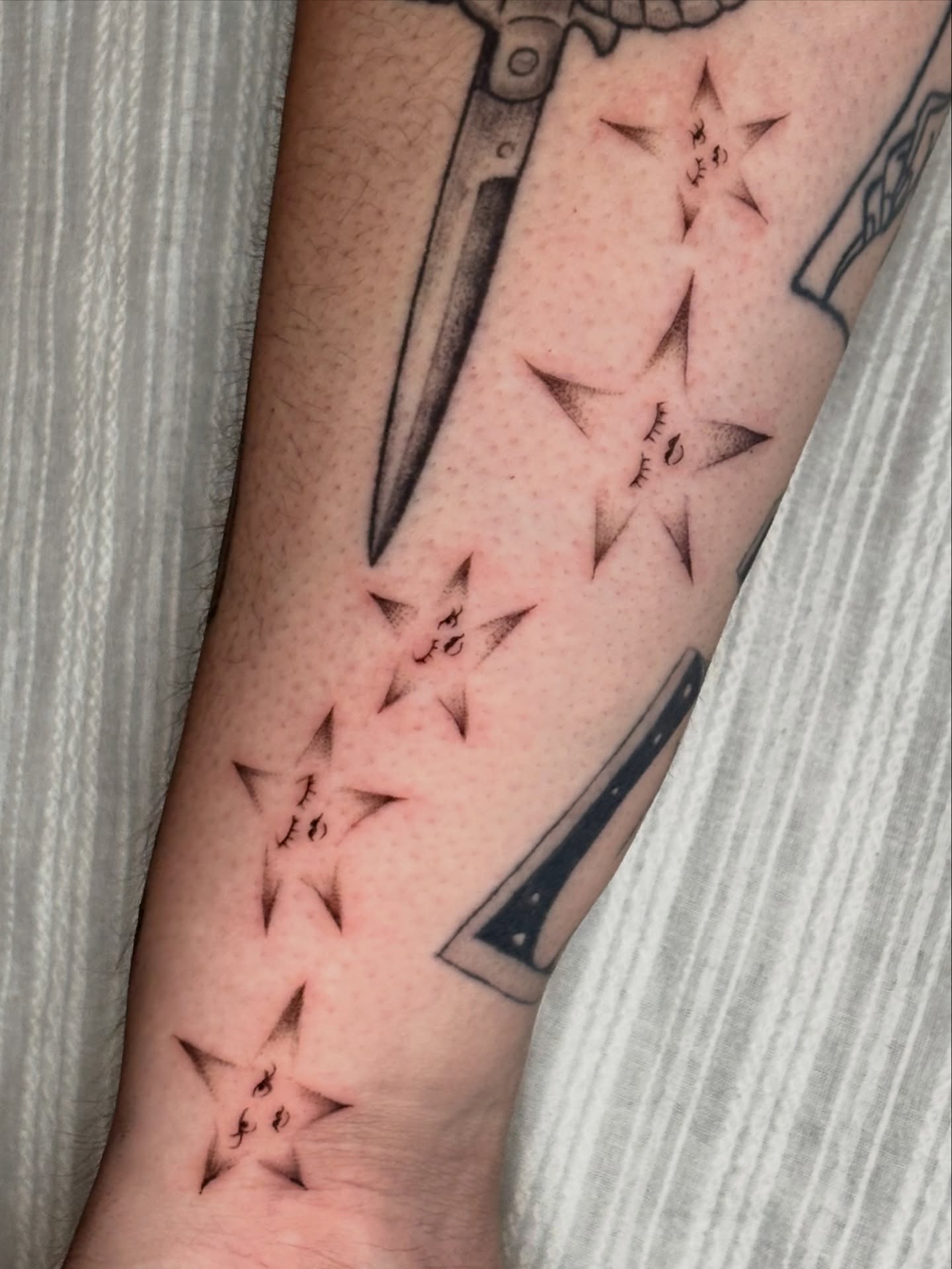 Stars black and grey tattoo on the forearm by Jojo Rose ✨ Denver Tattoo Artist
