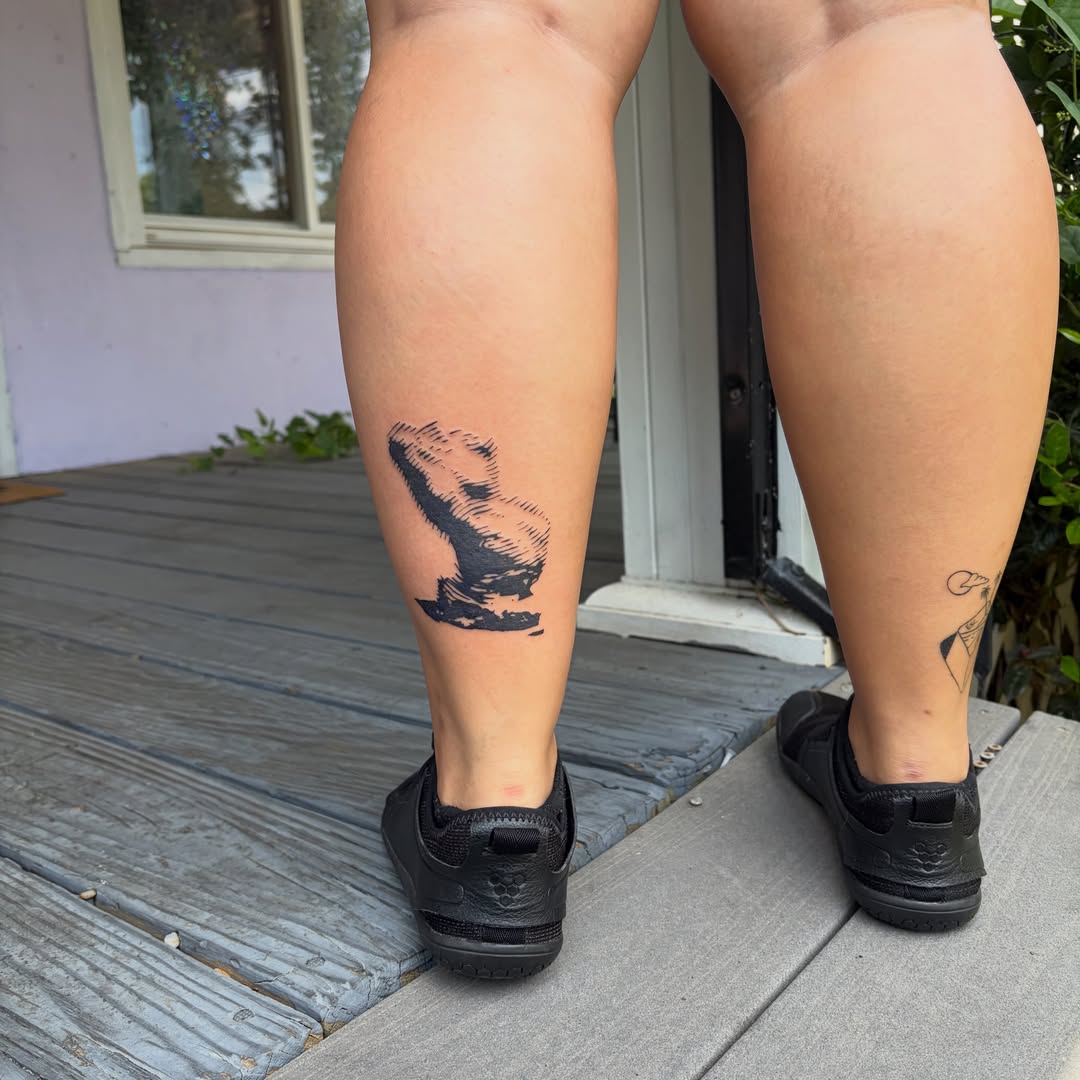 Bird black and grey tattoo on the calf by Rose DeLisse