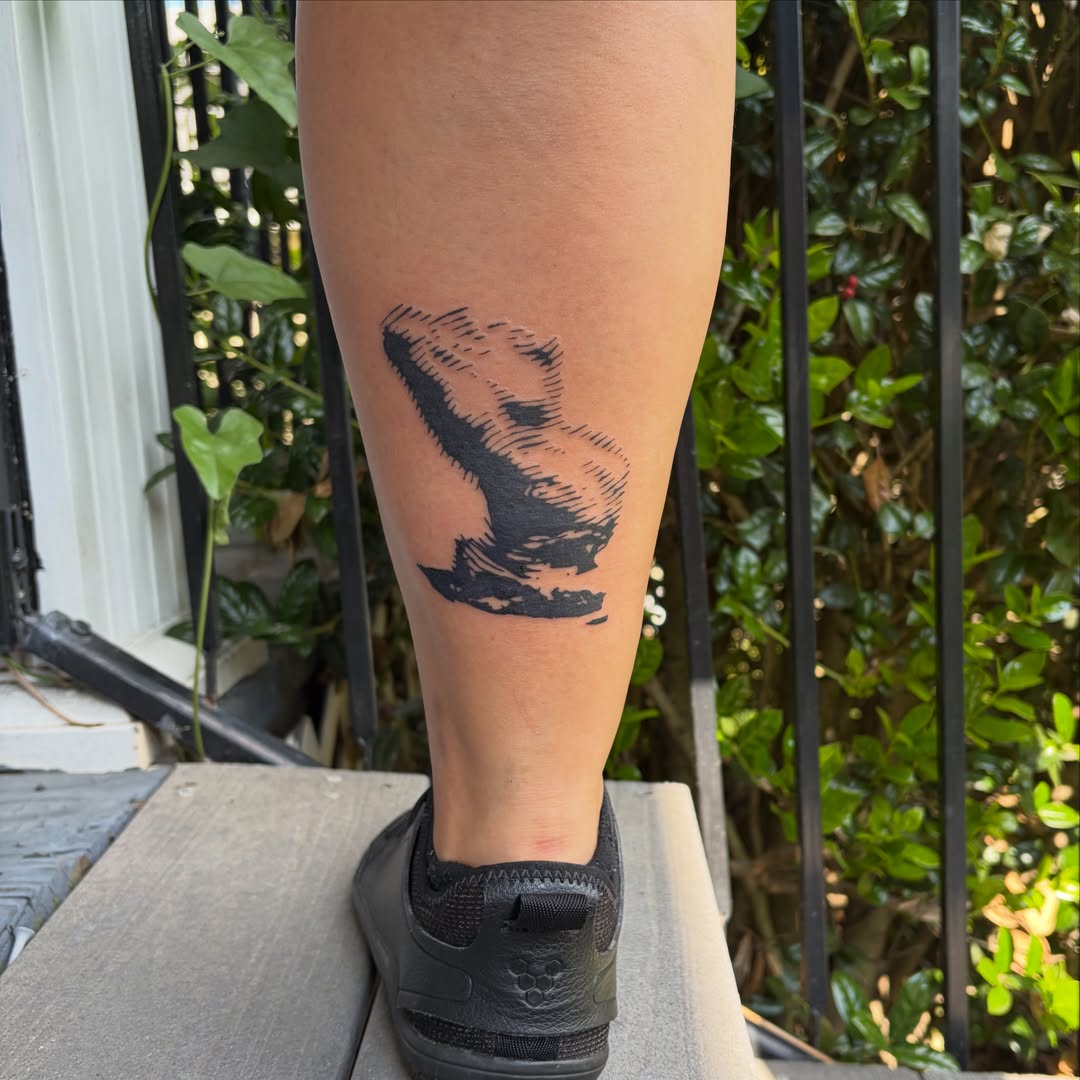 Dinosaur black and grey tattoo on the leg by Rose DeLisse