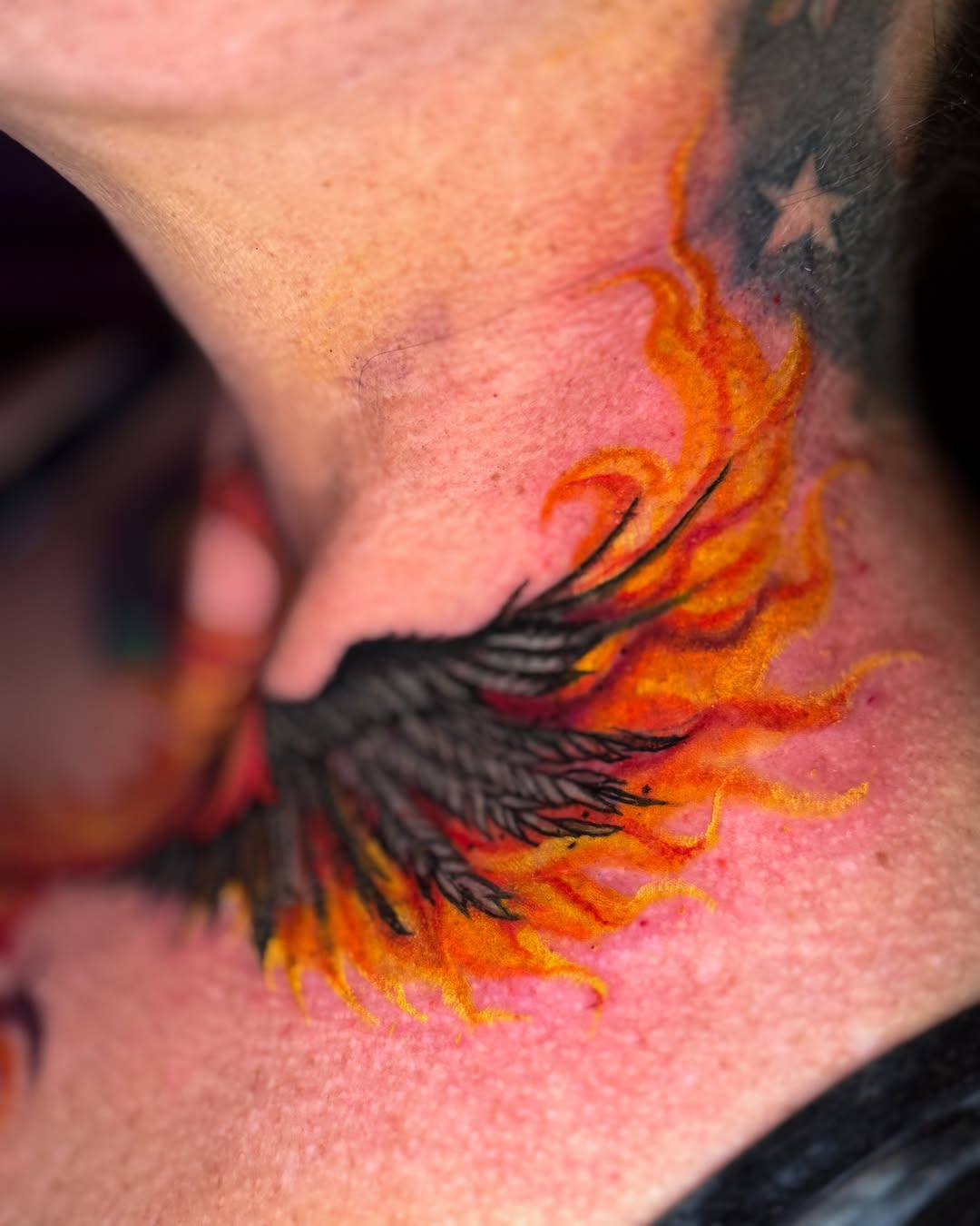 Flaming phoenix neo-traditional tattoo on the neck by Brandt Norcross