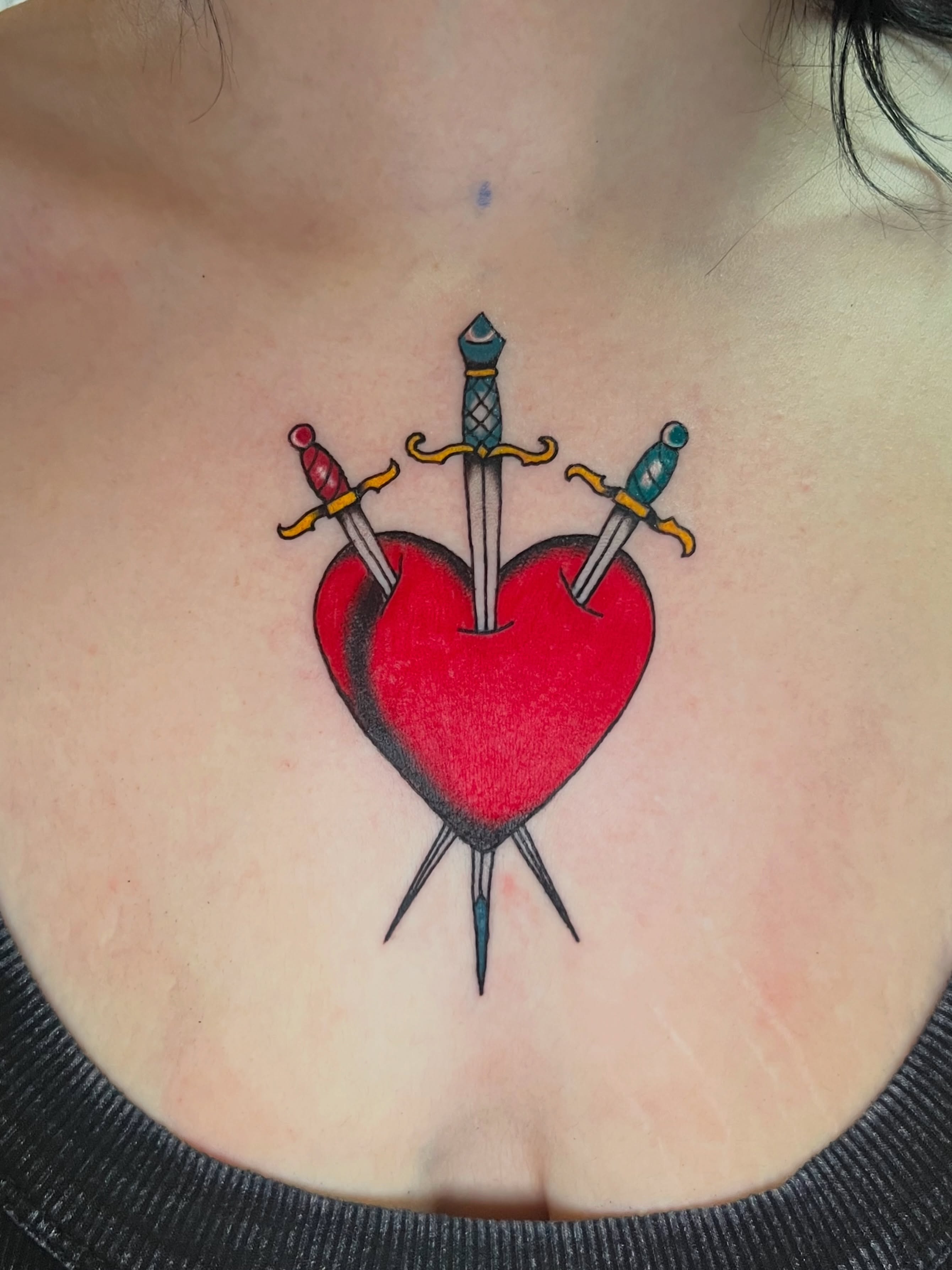 Heart with swords American traditional tattoo on the chest by Cincinnati Tattoo Artist, Cincinnati