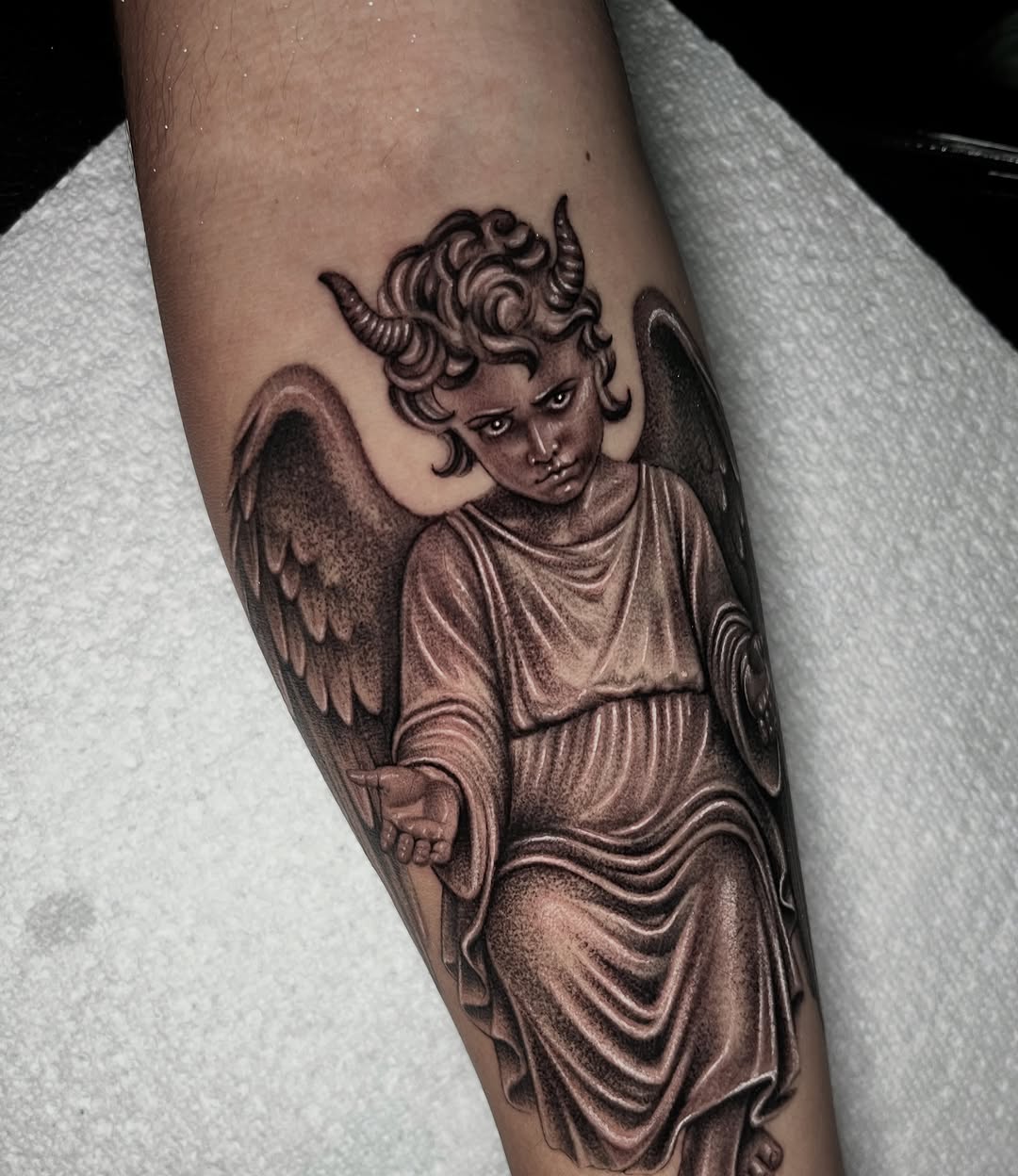 Cherub with horns realism tattoo on the forearm by Single Needle ๐ชฉ