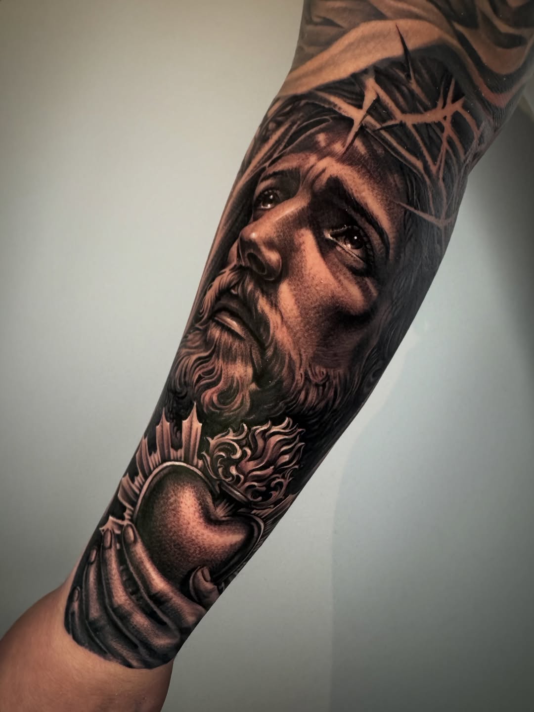 Jesus Christ with Sacred Heart Chicano tattoo on the forearm by David Torres