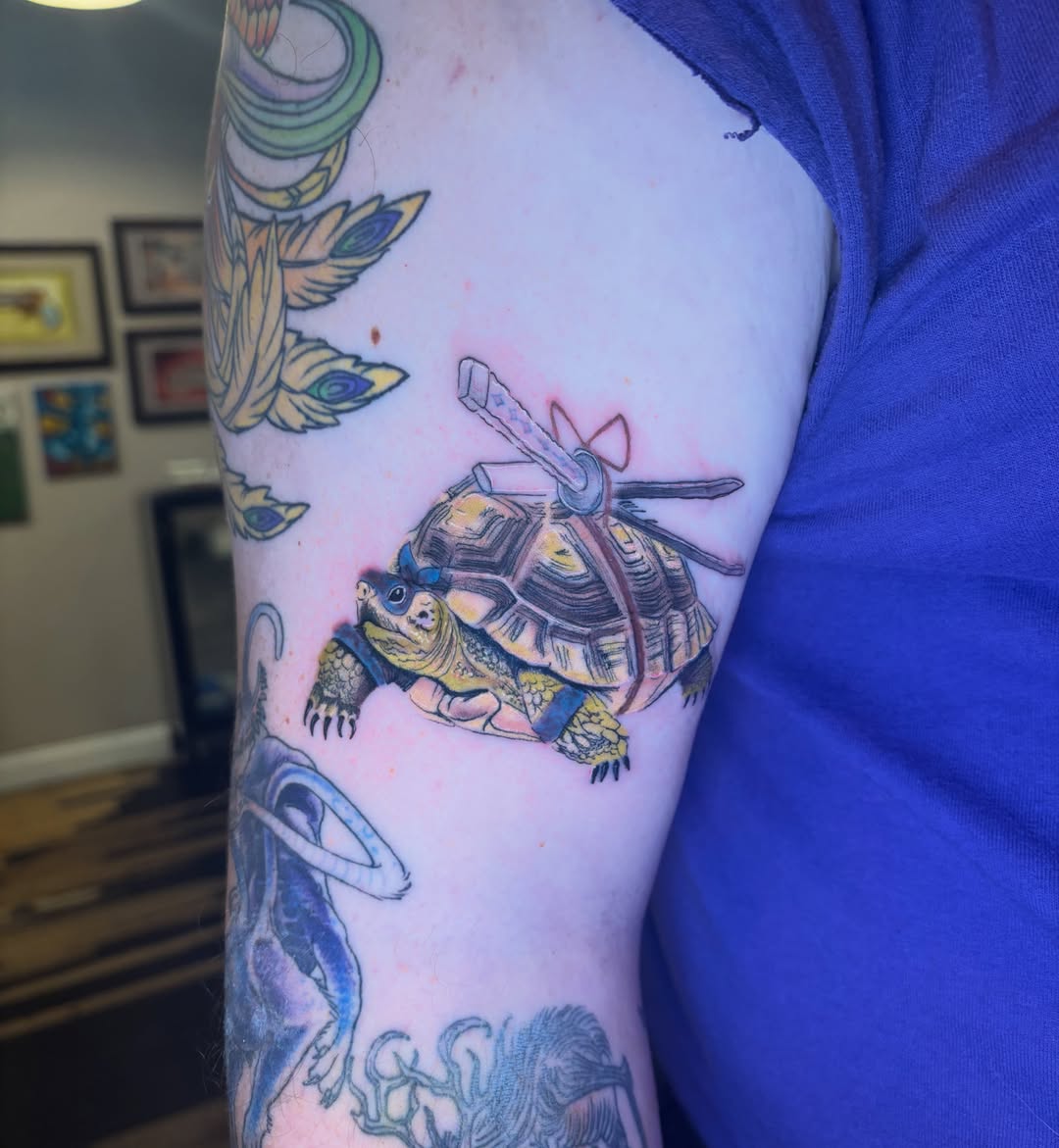 Turtle with katana watercolor tattoo on the forearm by Aubri Aunna