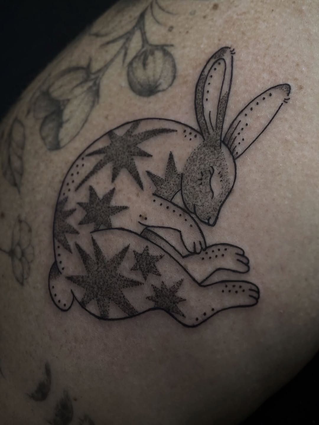 Rabbit with stars fine line tattoo on the thigh by Eden H., Columbus, Ohio