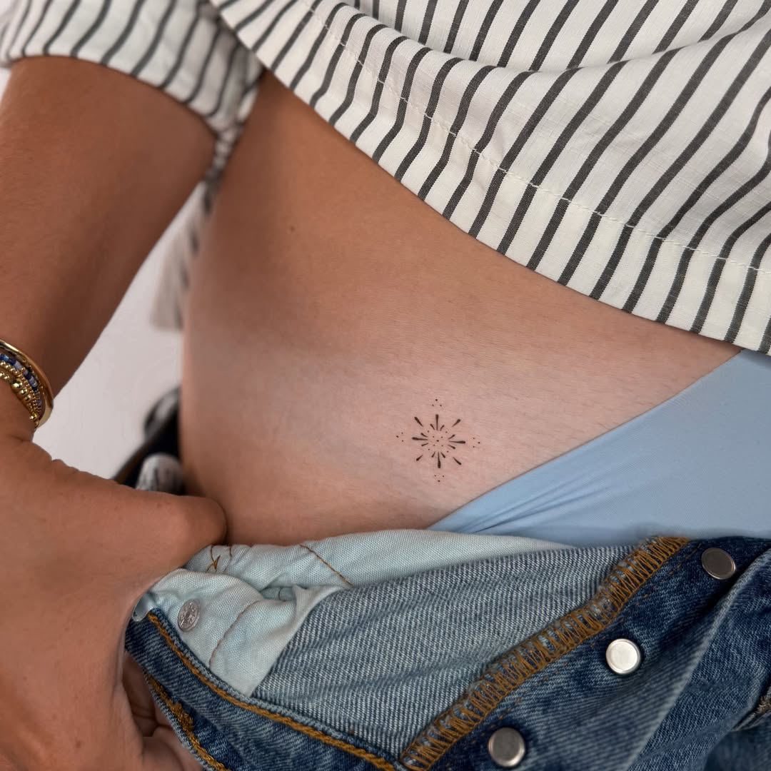 Geometric starburst dotwork tattoo on the ribs by Fineline Tattoos DFW