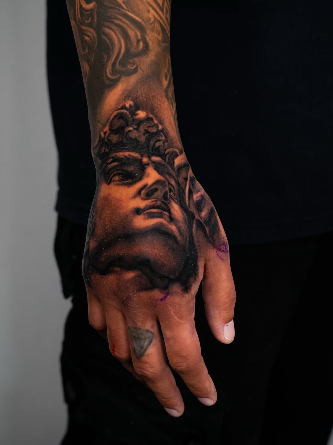Bust of David realism tattoo on the hand by Nate