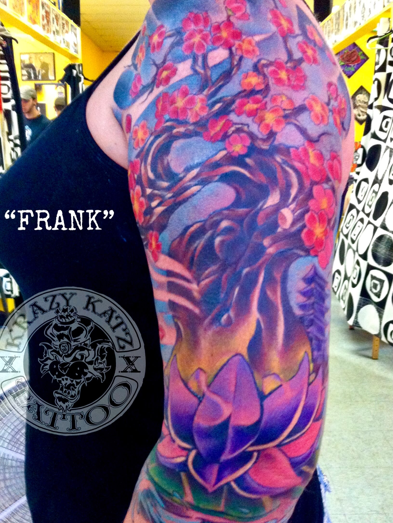 Cherry blossoms and lotus new school tattoo on the upper arm by Frank Gomez 🎨