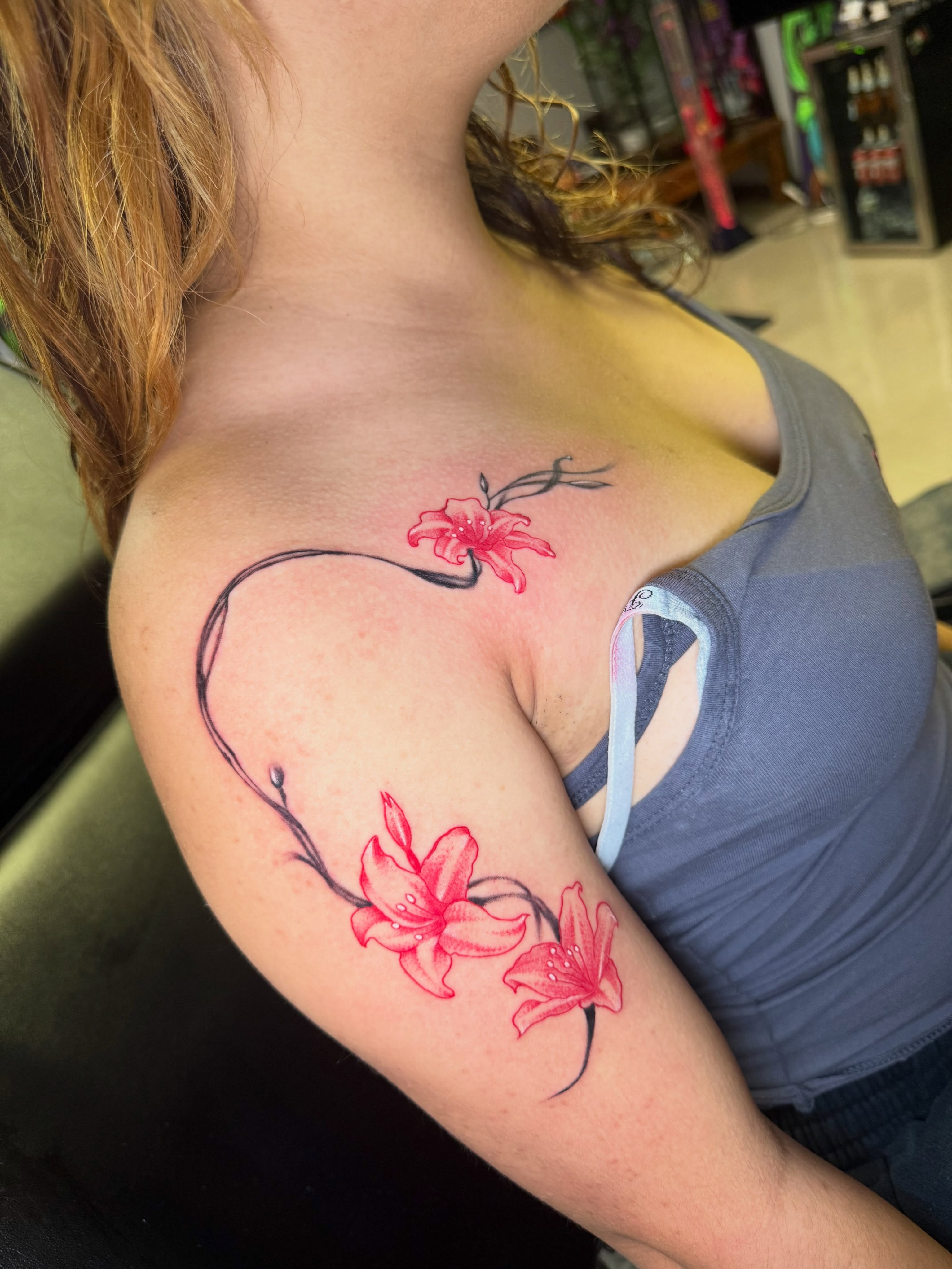 Flowers and heart fine line tattoo on the shoulder by Steve - Tattoo Artist