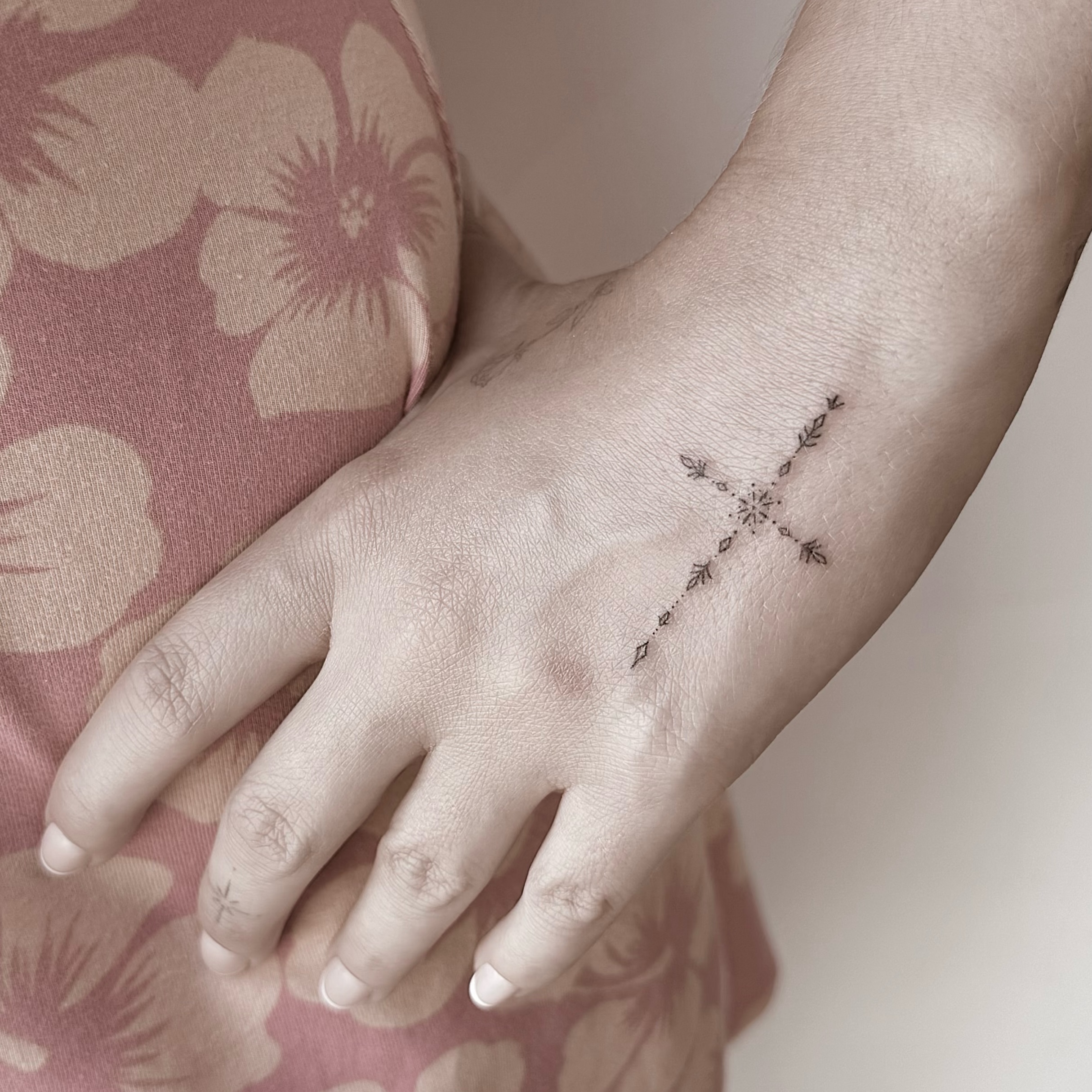 Cross with floral details fine line tattoo on the forearm by Chanel Picquelle, Nashville, Tennessee