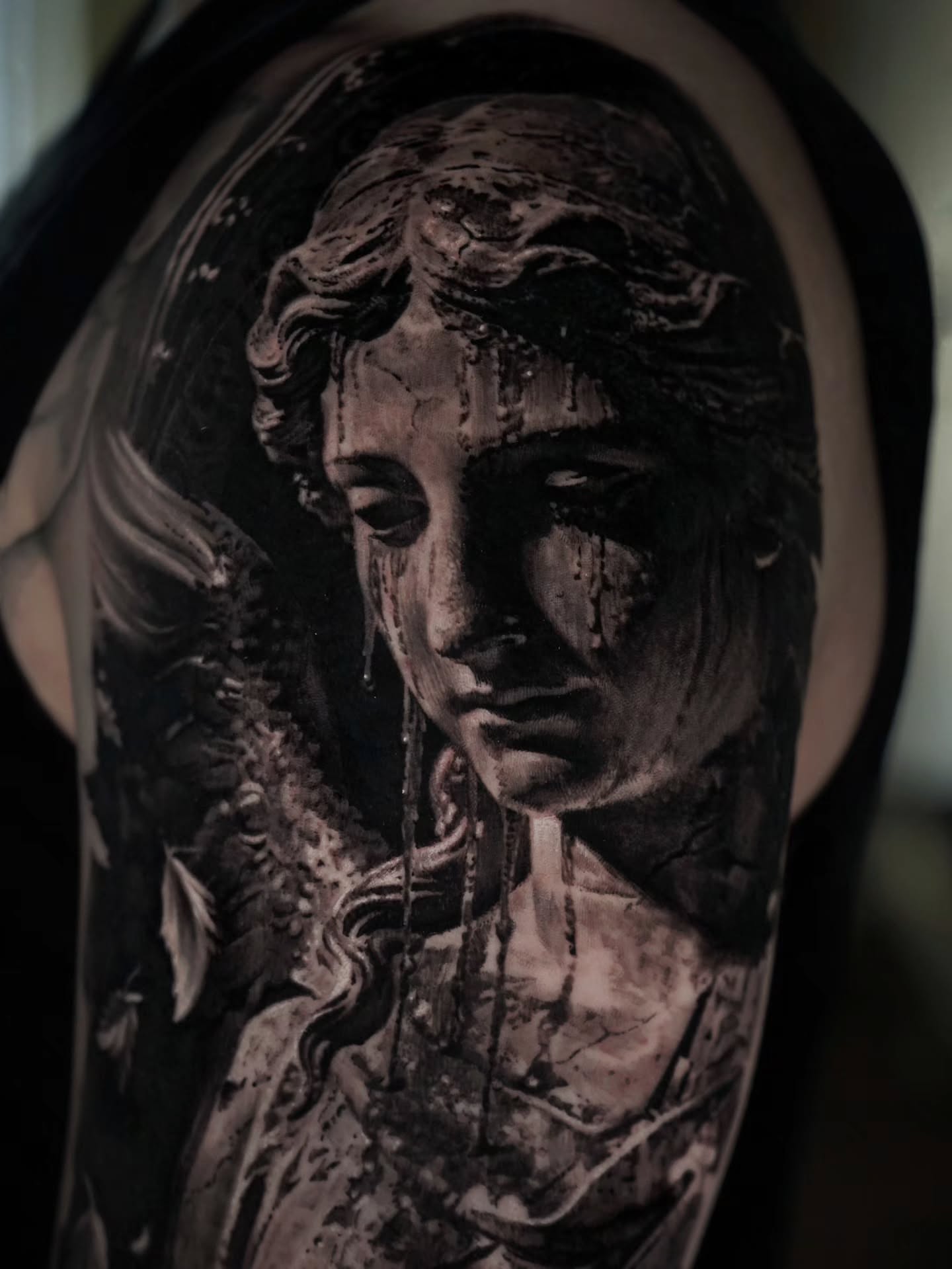 Statue head realism tattoo on the shoulder by Owen Paulls