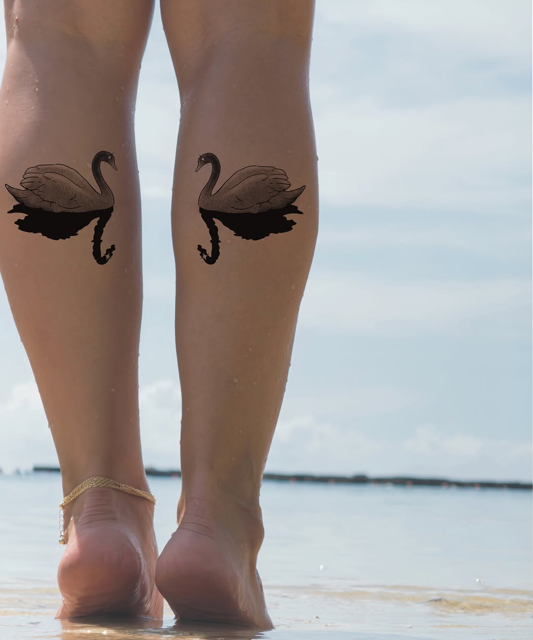 Swan black and grey tattoo on the calf by Elana Hites