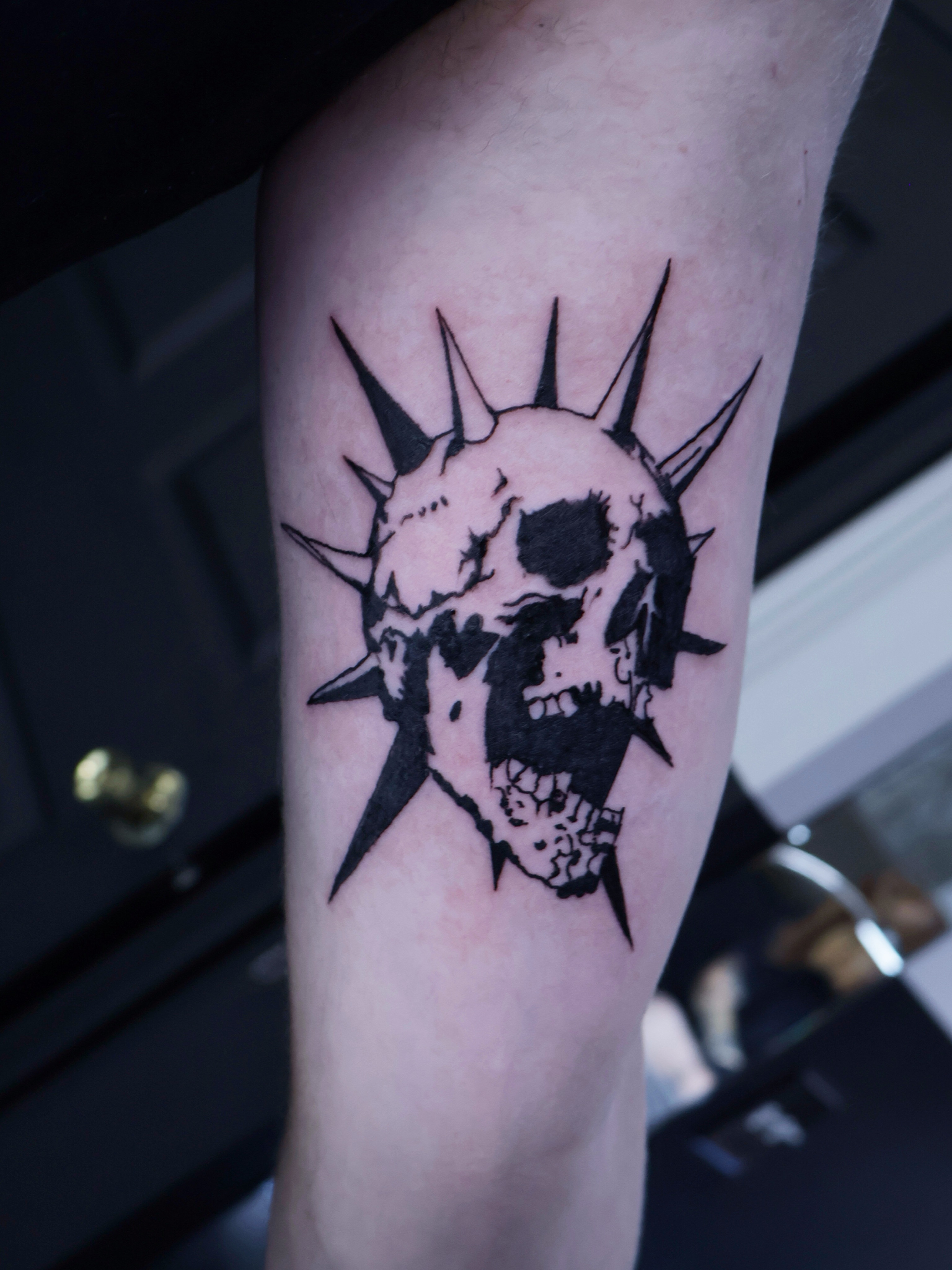 Skull with spikes black and grey tattoo on the forearm by Denis Du Preez, East Williamsburg, Brooklyn