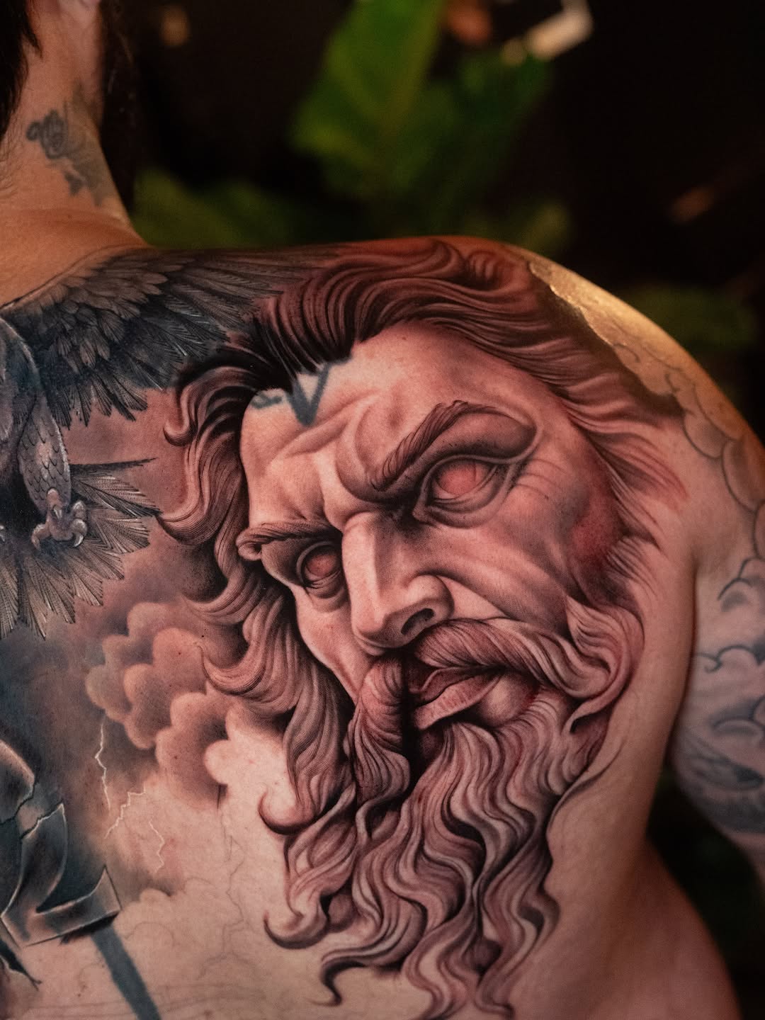 Zeus portrait with eagle and clouds realism tattoo on the shoulder by Franz Muñoz